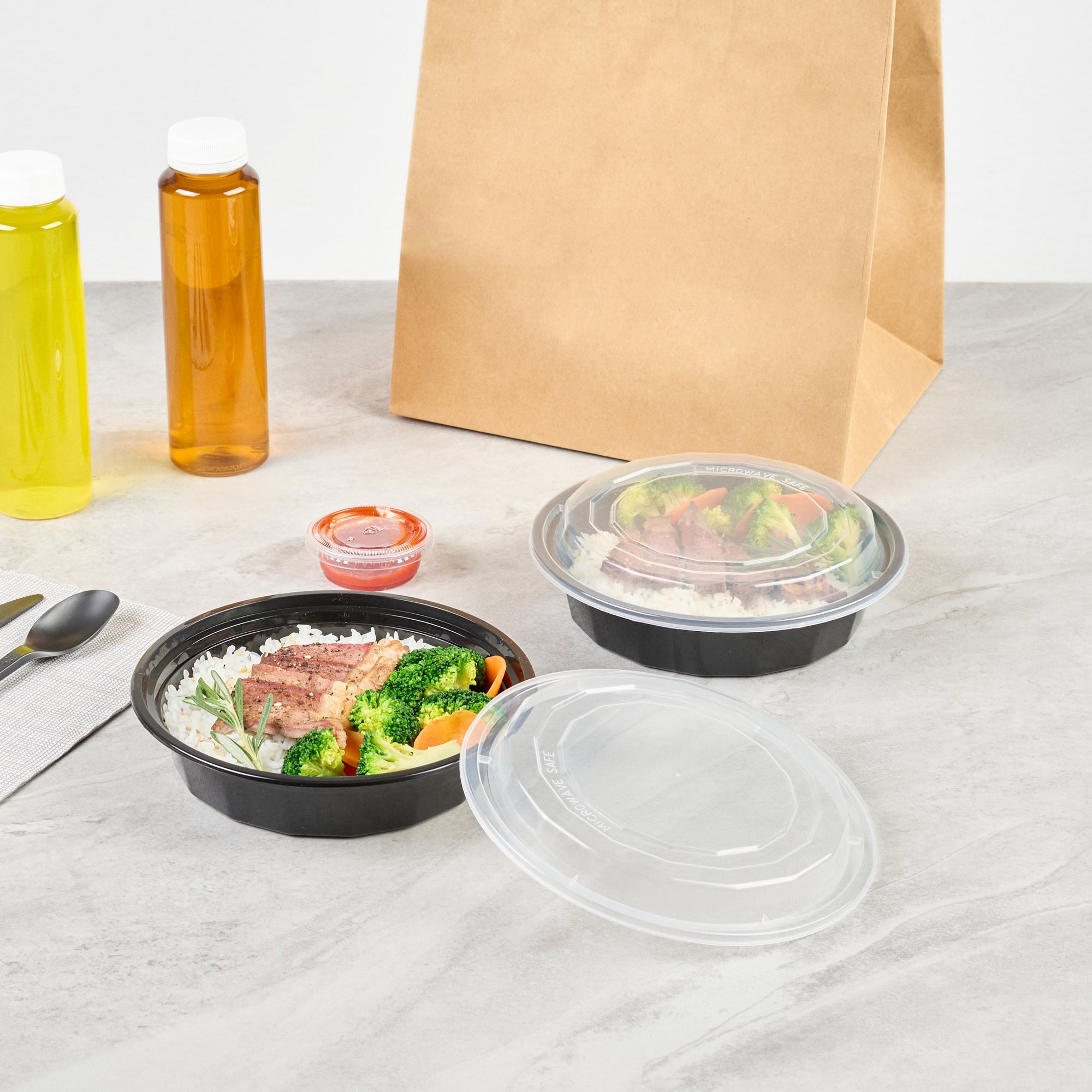 24 oz Black Round Plastic Takeout Containers with Clear Lids - Microwave Safe (7.25