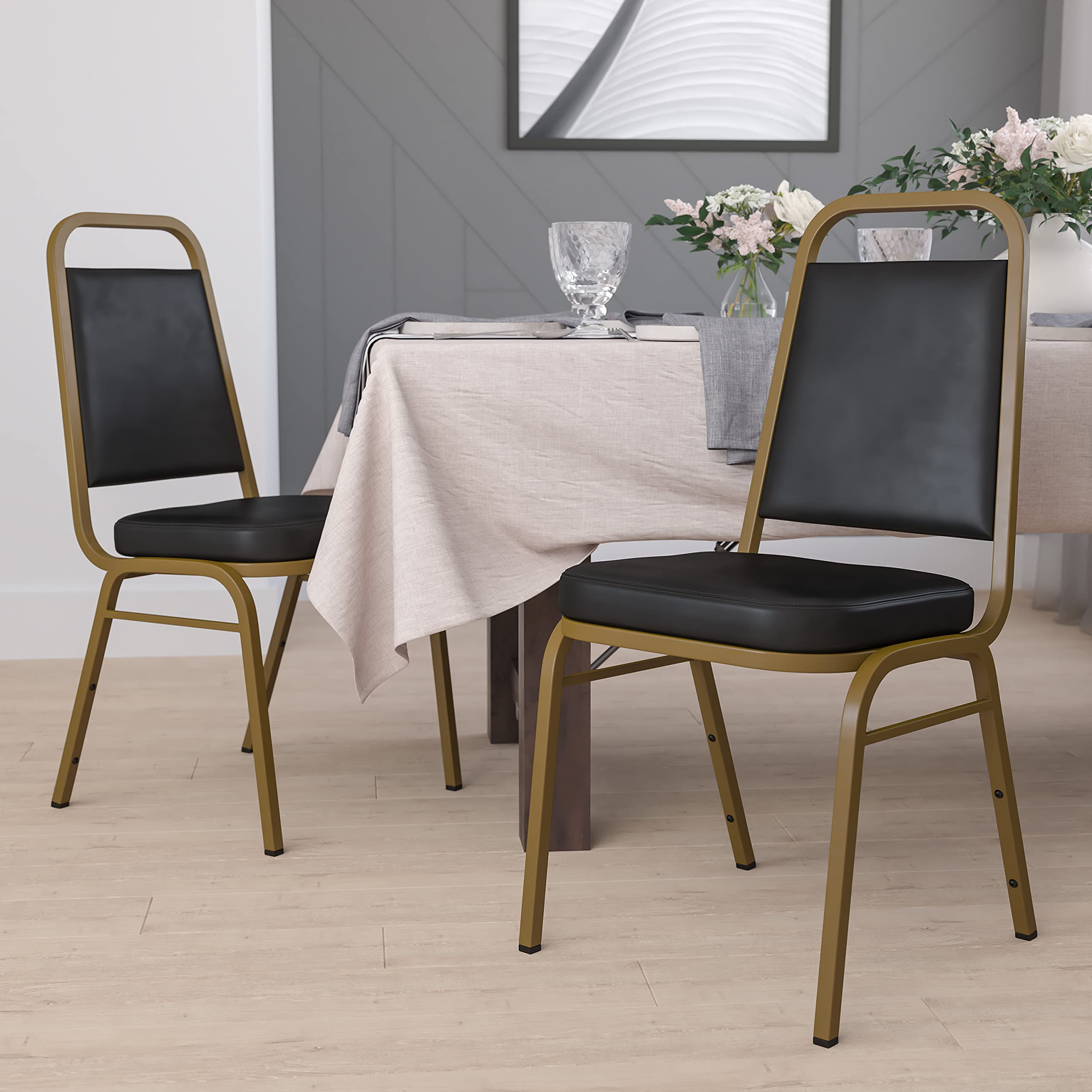 4 Pack Black Vinyl Trapezoidal Stacking Banquet Chairs with Gold Frame - Perfect for Weddings, Events, and Conference Room Seating
