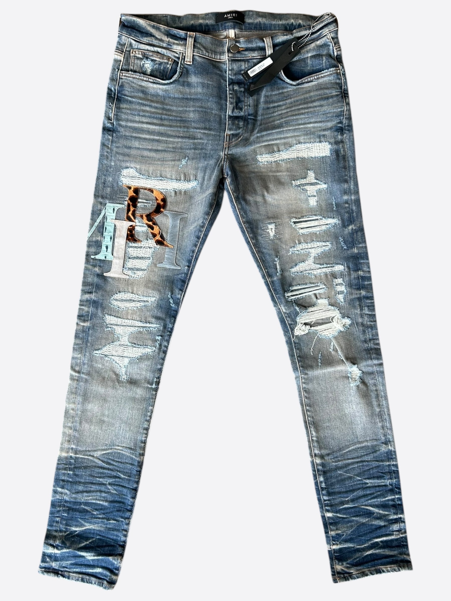 Amiri Vintage Indigo Leather Multicolor Staggered Logo Jeans for Men - Distressed Denim Pants with Leather Accents | Perfect for Streetwear & Casual Outfits