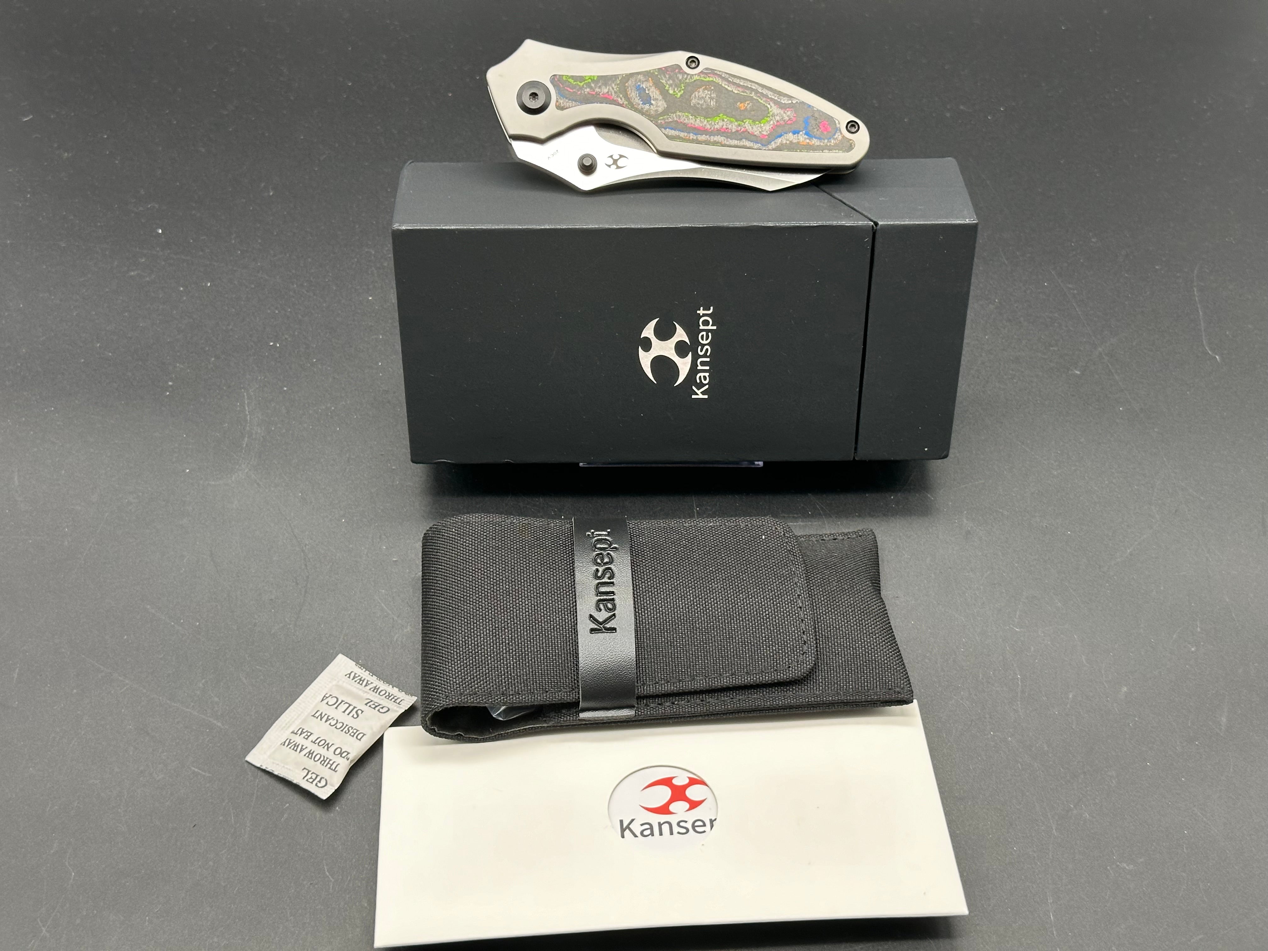 KANSEPT BABA YAGA Folding Pocket Knife - Titanium Handle with 80s Camo Carbon Fiber Inlay, 20CV Steel Plain Edge Blade - EDC, Camping, Outdoor Survival Gear