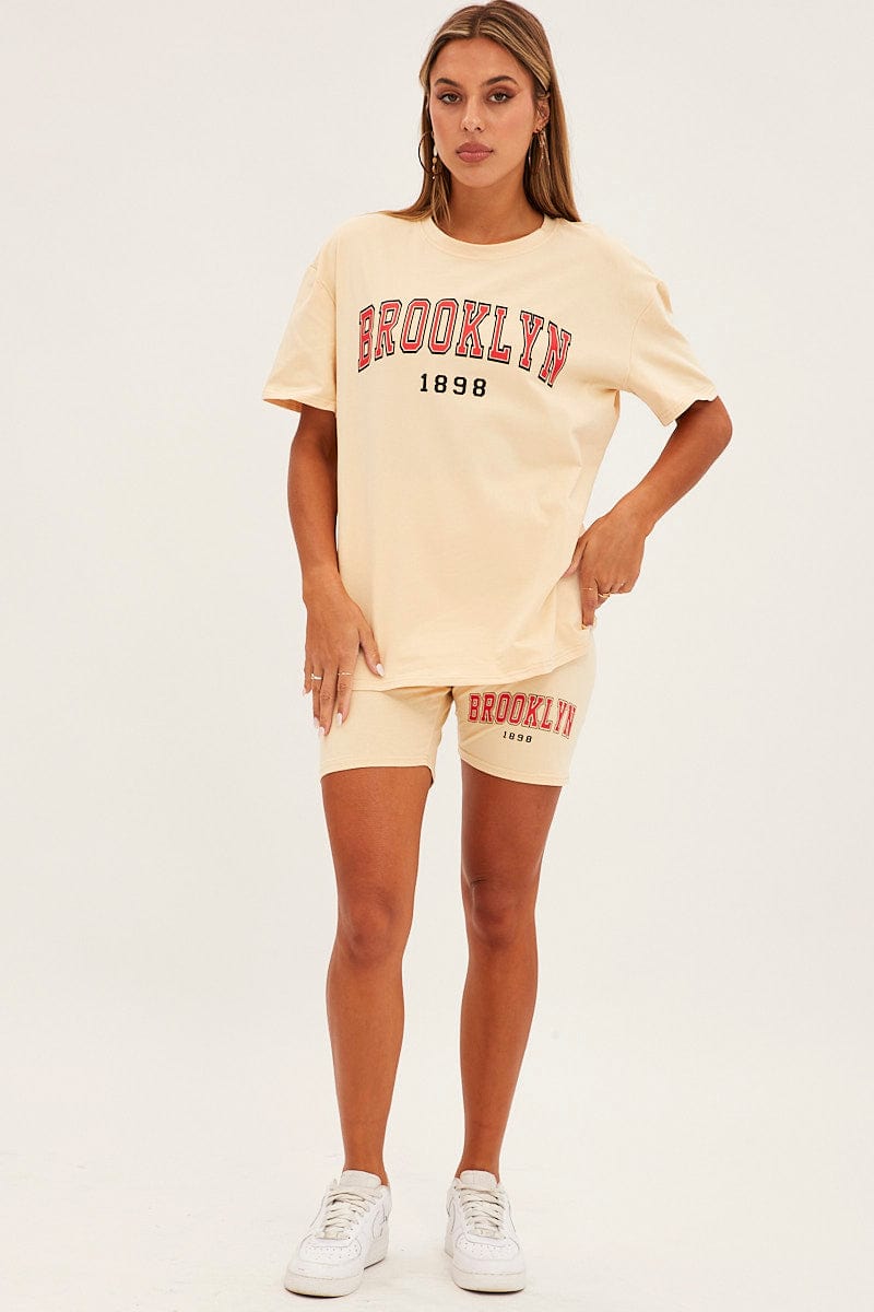 Trendy Beige Graphic T-Shirt & Biker Shorts Set for Women | Casual Streetwear Outfit | Perfect for Gym, Yoga & Summer Fashion