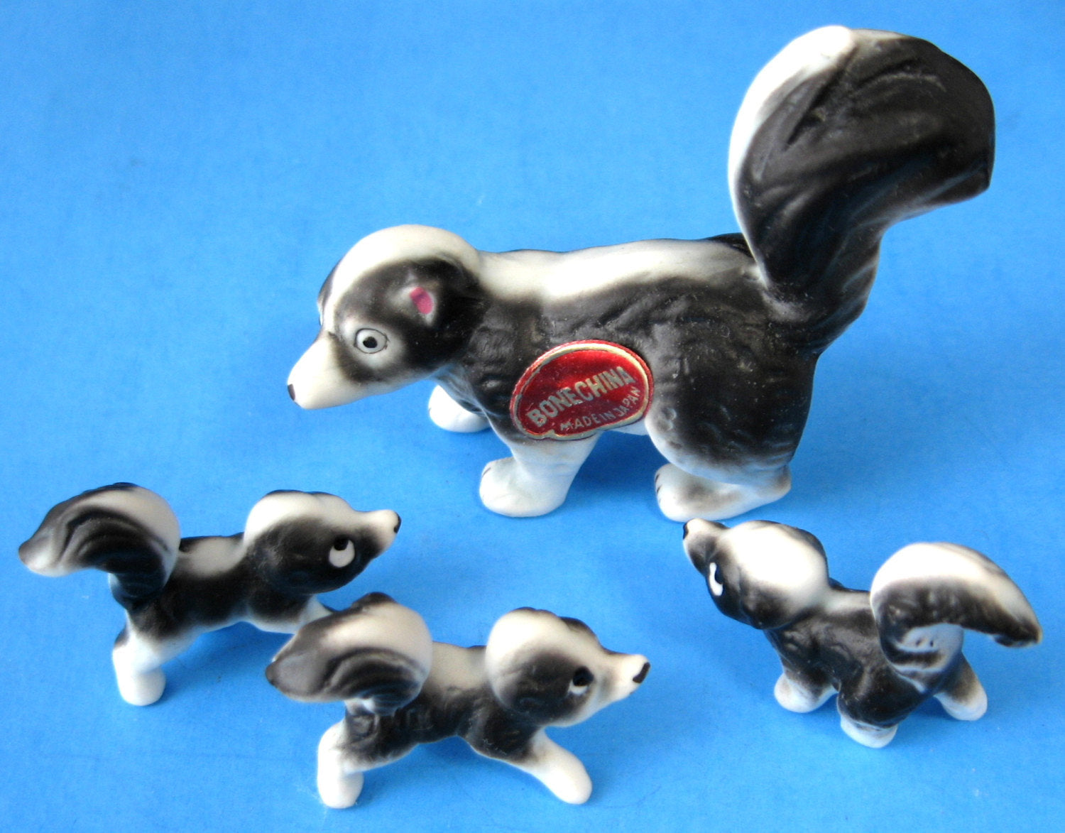 Skunk Family Figurines Set of 4 - Premium Bone China Collectibles with Original Box & Sticker (Made in Japan) - Perfect for Home Decor, Gift Giving, and Animal Lover Collections