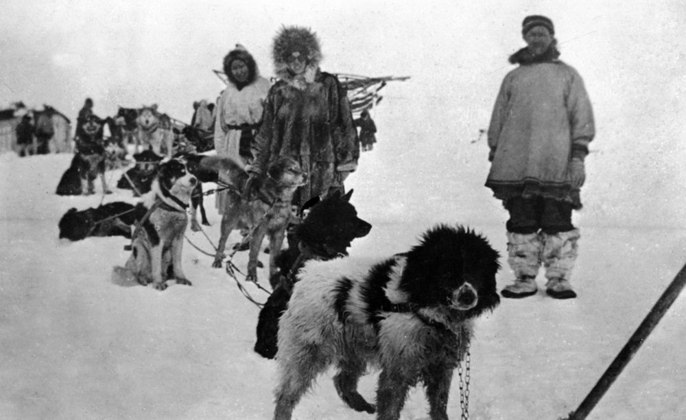 Alaska Dog Sled Team with Men in Parkas - 12x18 Framed Wall Art Poster for Living Room, Bedroom & Office Decor - Perfect for Winter Themed Home Decor & Adventure Lovers