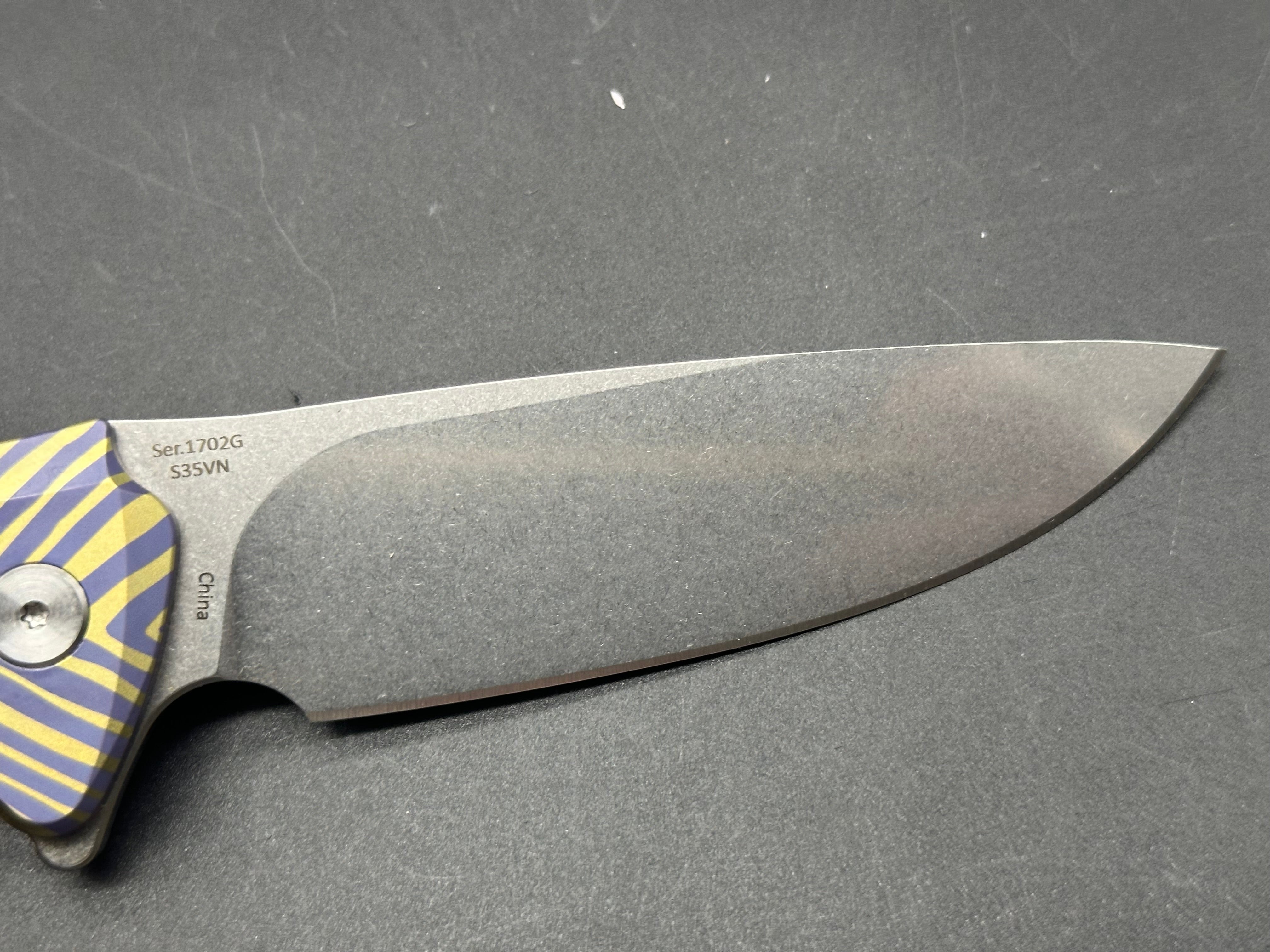 Artisan Cutlery Traditional S35VN Stainless Steel Drop Point Folding Knife with Gold & Blue Anodized Titanium Handle - Perfect for Camping, Hunting, and Everyday Carry (EDC)