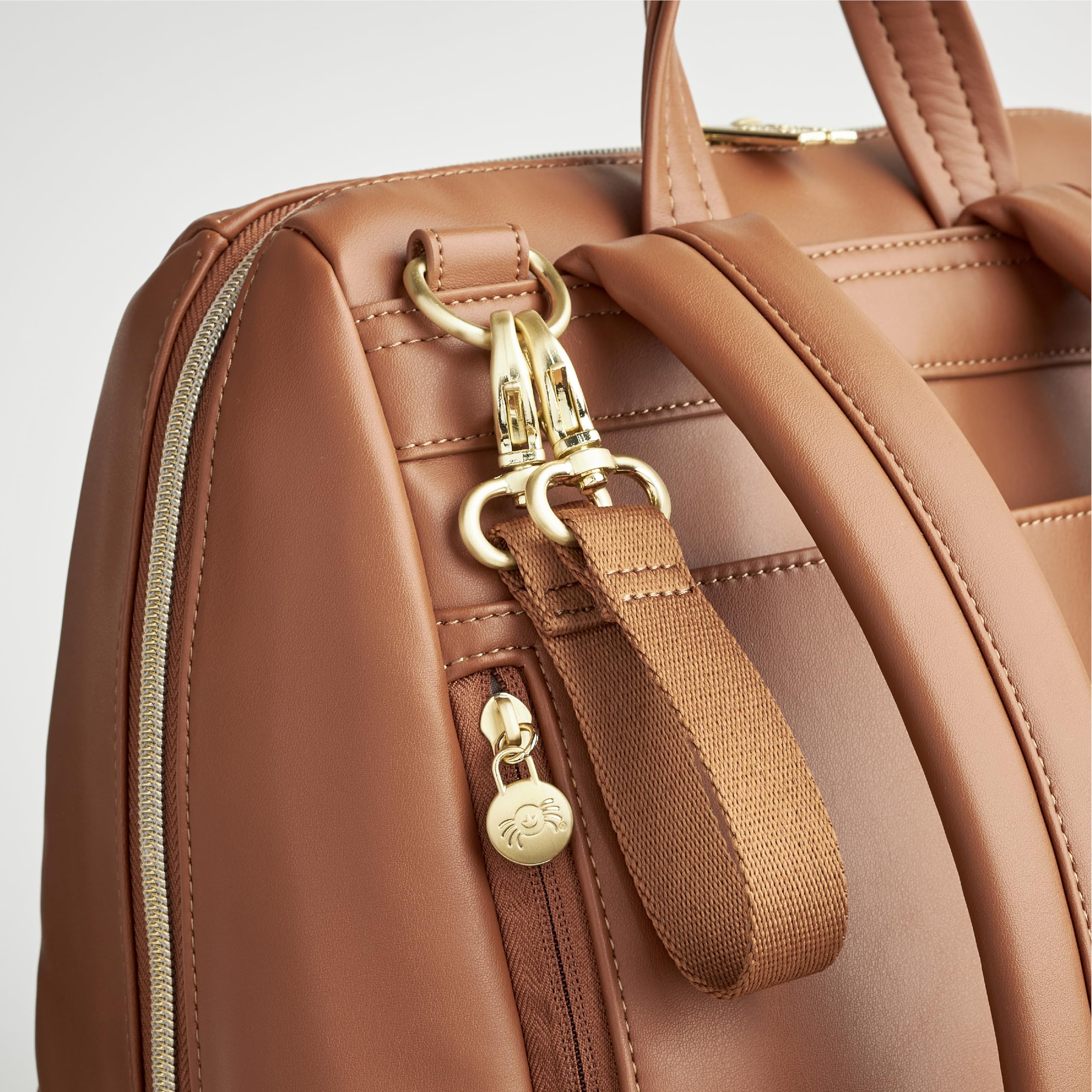 Itzy Ritzy Eras Diaper Bag Backpack – Spacious Baby Backpack with 15 Pockets, Neutral Design, Changing Pad & Stroller Straps | Perfect for Travel, Daycare & On-the-Go Parents (Cognac)
