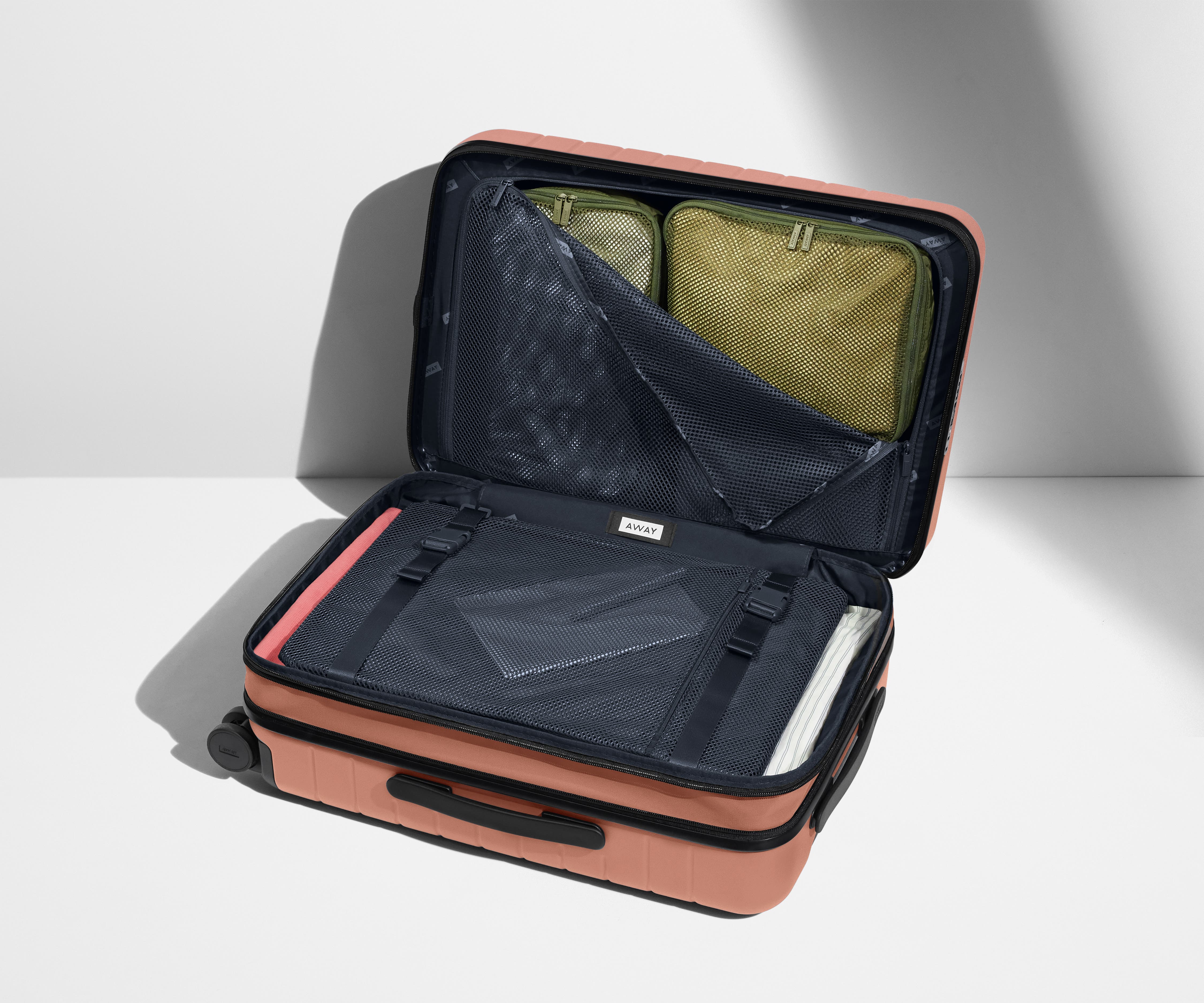 The Carry On Flex in Clay Pink - Lightweight Expandable Luggage for Travel, Business Trips & Weekend Getaways
