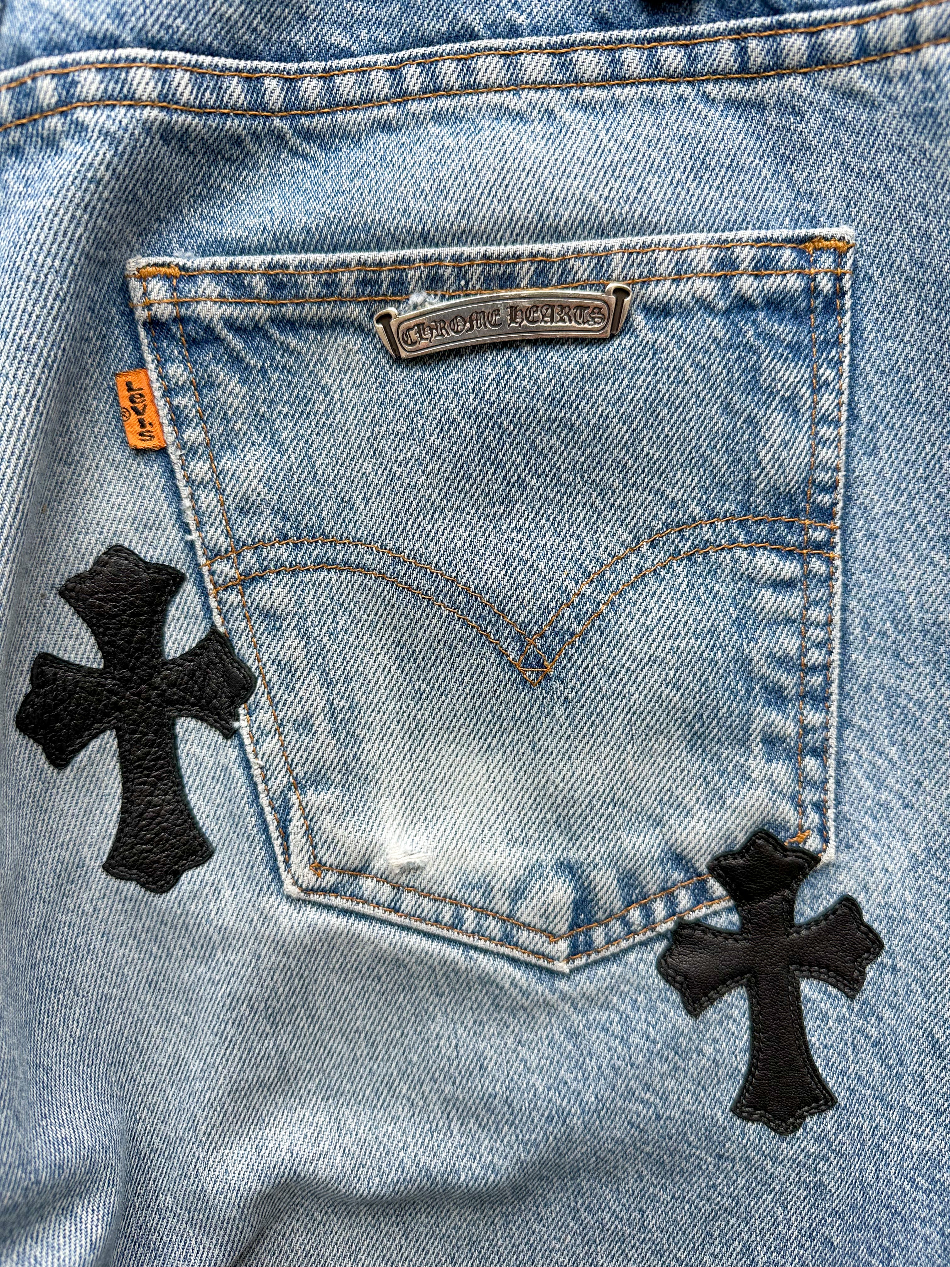 Chrome Hearts x Levi's Light Blue Distressed Jeans with Black Leather Cross Patch - Stylish Vintage Denim for Men's Streetwear & Casual Outfits