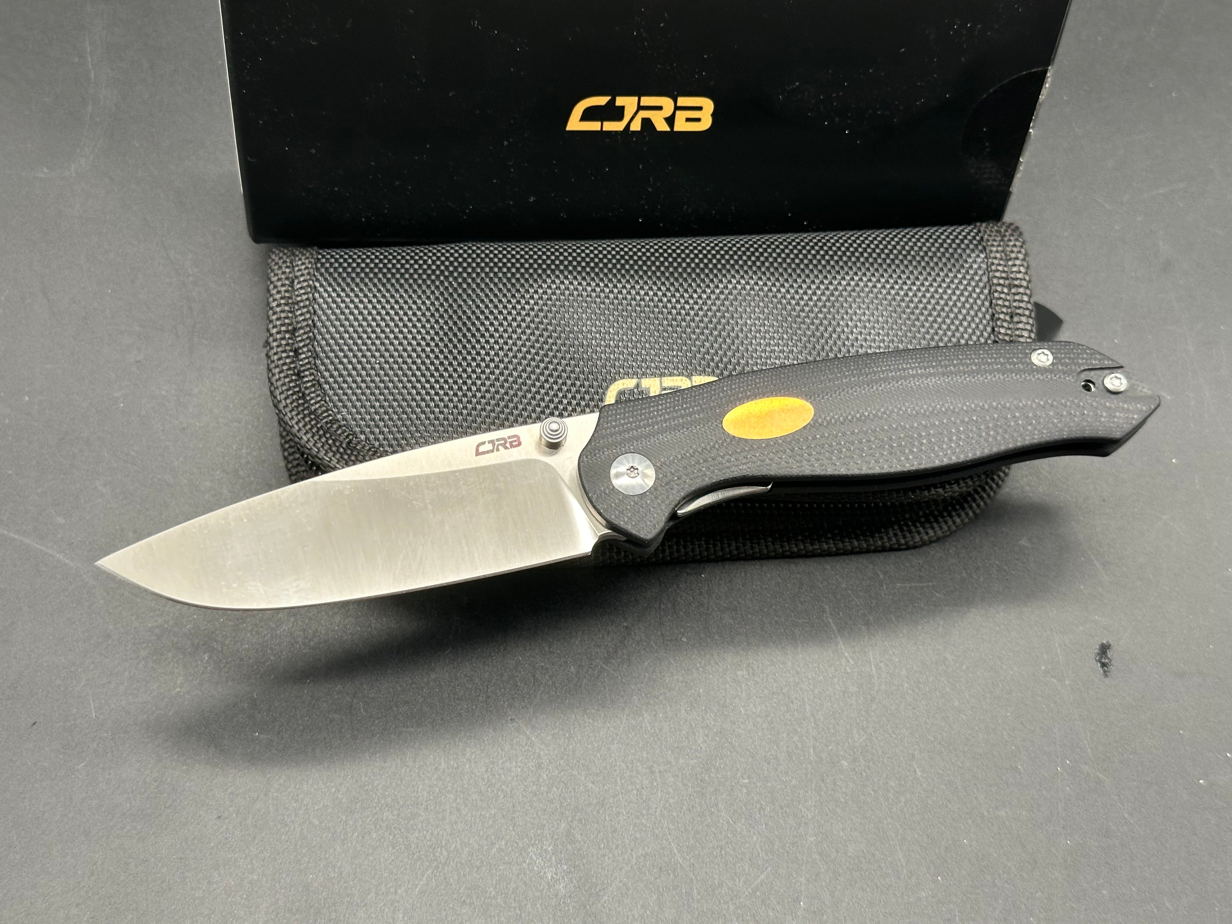 CJRB AES Folding Knife - Black G10 & Brass Handle, AR-RPM9 Steel, Drop Point Plain Edge, Sand Polish Finish - EDC, Camping, Outdoor Survival
