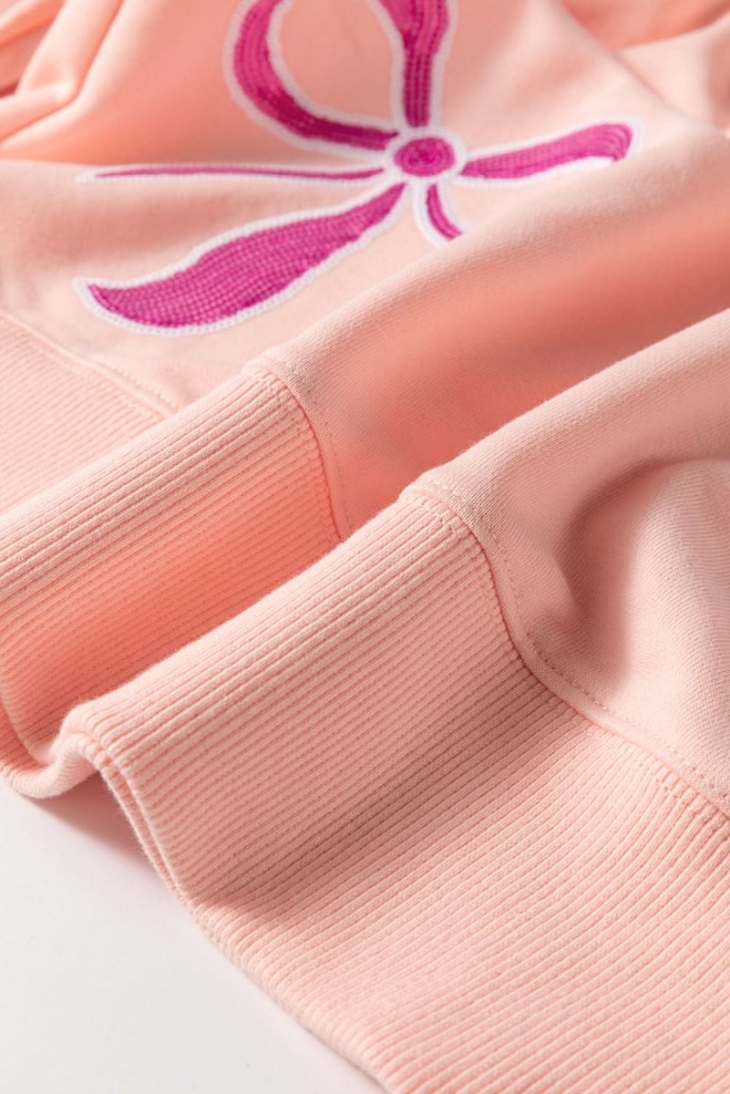 Stylish Apricot Pink Sequined Bowknot Drop Shoulder Oversized Sweatshirt for Women | Trendy Loose Fit Pullover | Perfect for Casual Outings, Parties & Date Nights