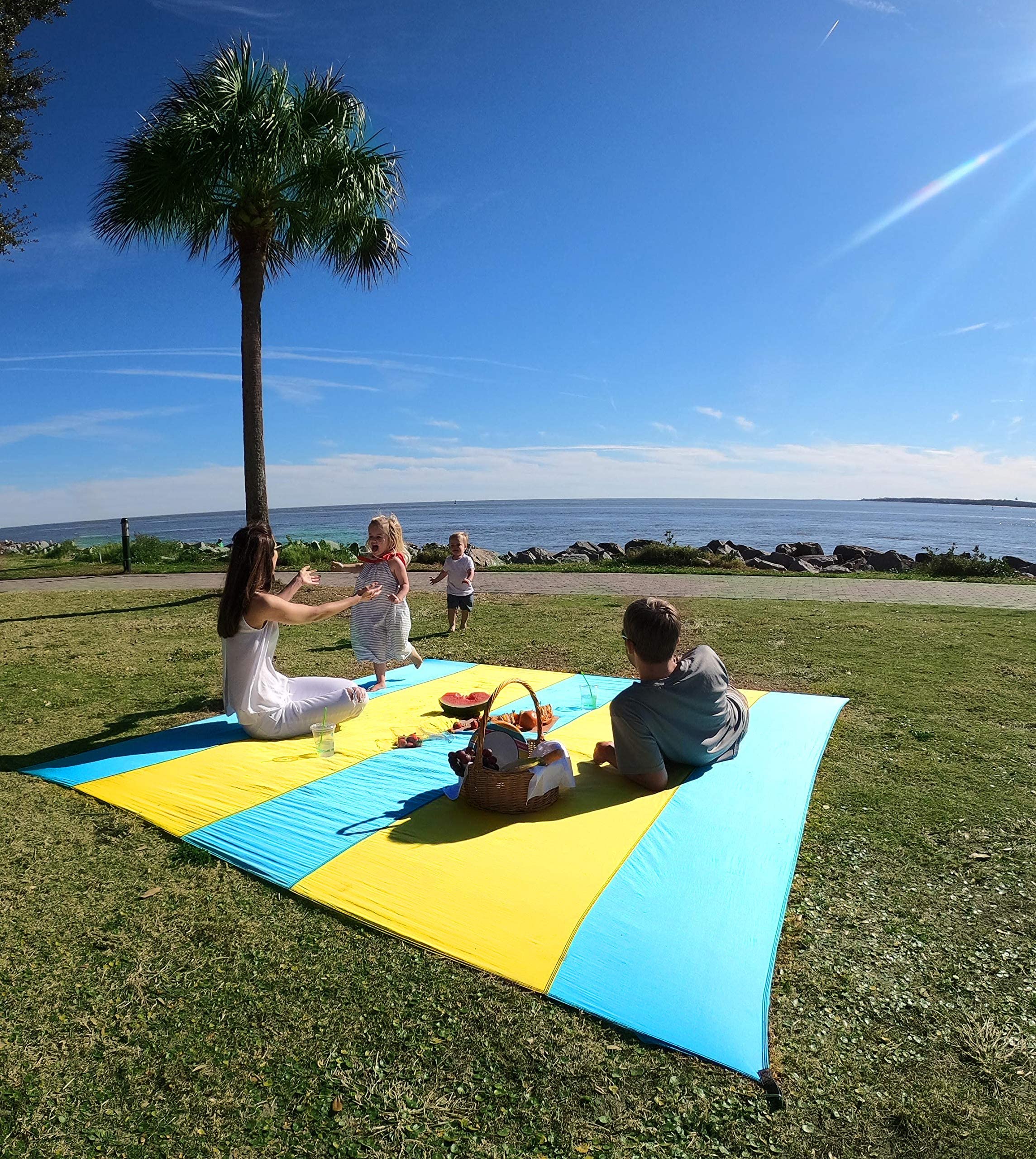 Extra Large 10ft x 9ft Sandproof Waterproof Quick Dry Beach Blanket - Portable Picnic Mat with 4 Metal Stakes & Corner Pockets for 1-8 Adults - Includes Carrying Bag & Secure Clip - Perfect for Beach, Park, Camping and Outdoor Activities