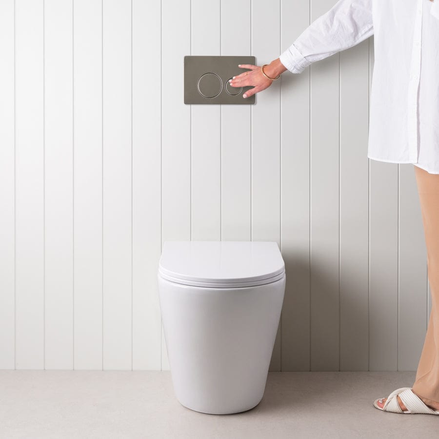 Angled In-Wall Toilet with Round Stainless Steel Buttons - Modern Space-Saving Bathroom Solution for Small Homes and Apartments