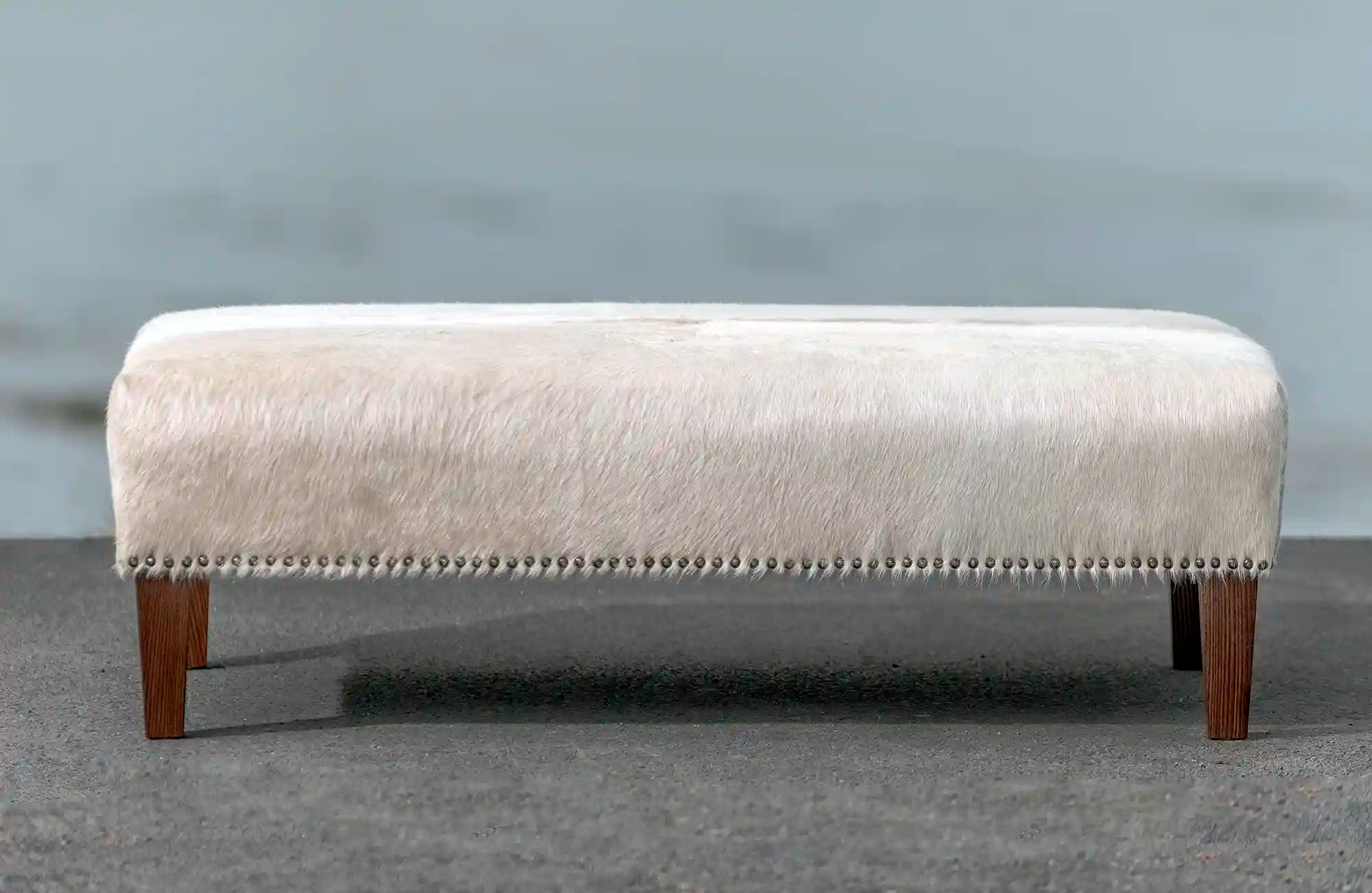 Premium Cowhide Ottoman with Reddish Wood Legs - 43