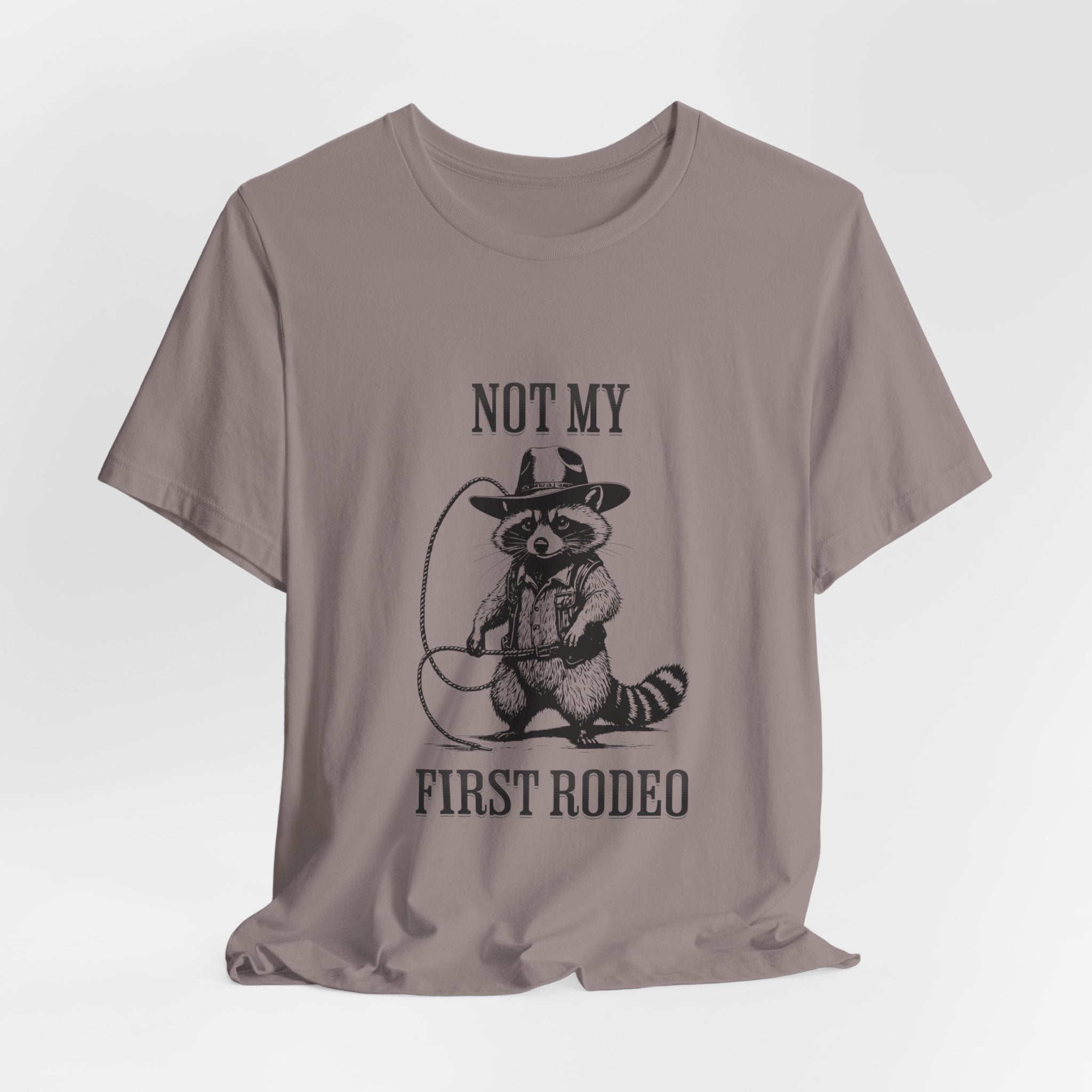 Funny Western Graphic Cotton Tee - Not My First Rodeo Cowboy Raccoon Shirt | Cute Quirky Country Style T-Shirt for Rodeo Fans & Animal Lovers | Perfect for Rodeo Events, Country Concerts & Casual Wear