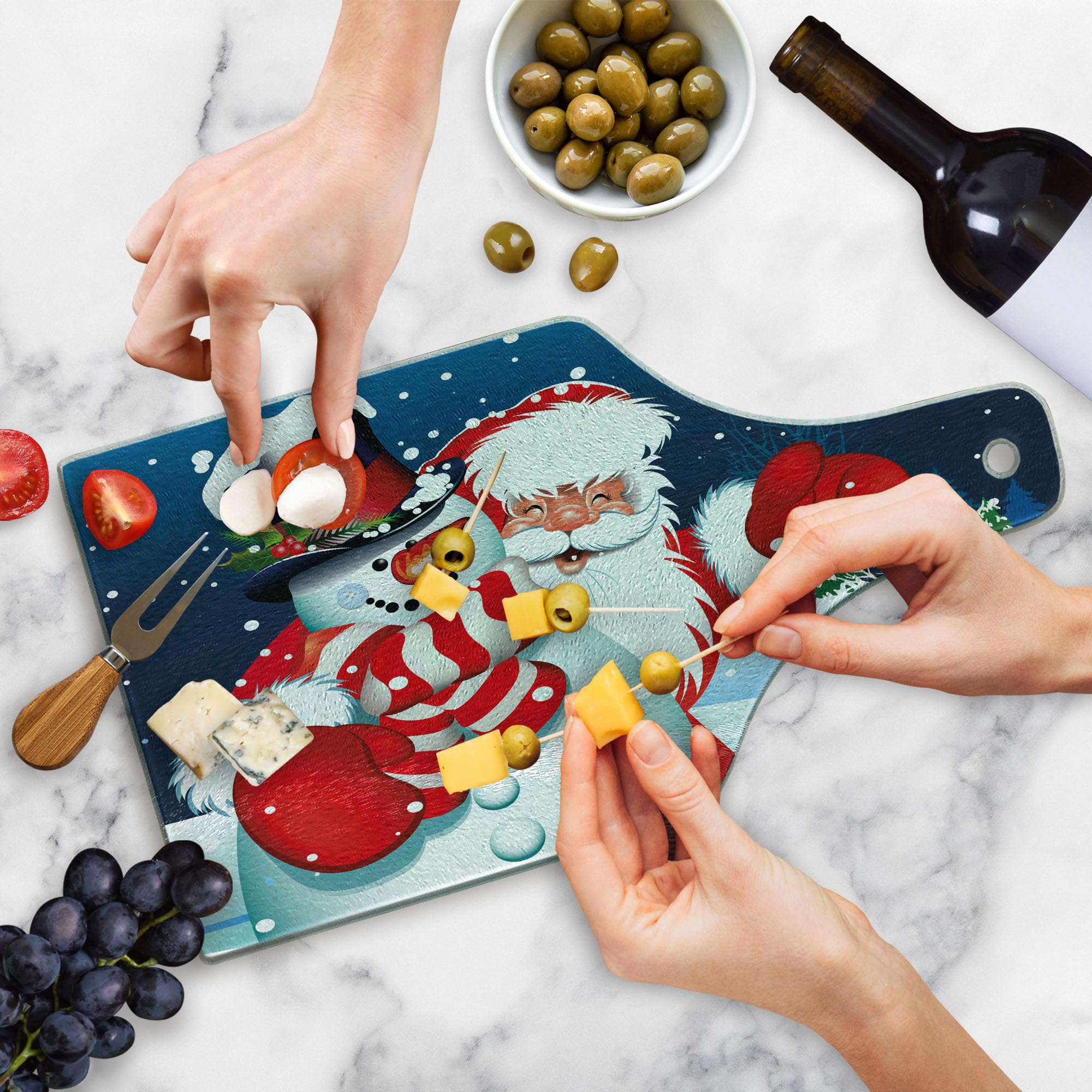 Ambesonne Christmas Cutting Board - Smiling Santa Claus Hugging Snowman on Winter Hills with Fir Trees - Durable Tempered Glass Serving Board in Wine Bottle Shape (Blue, Red, White) - Perfect for Holiday Entertaining, Cheese Platters & Festive Decor