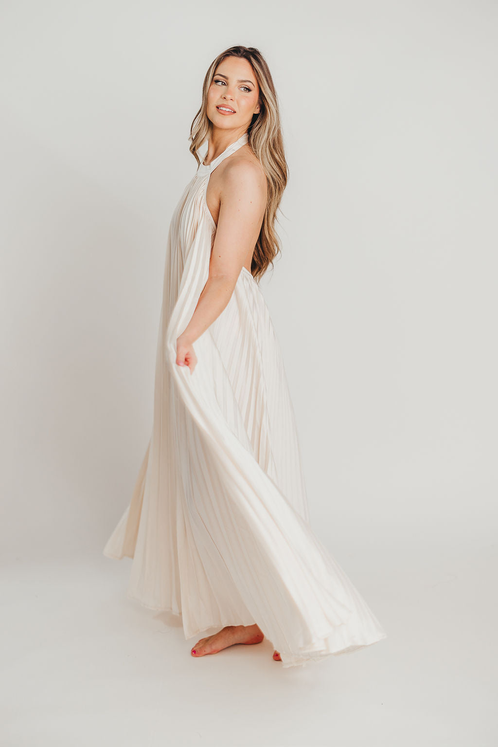 Maren Pleated Halter Maxi Dress in Cream - Bump Friendly Maternity Dress for Pregnancy, Nursing & Special Occasions | Flowy Summer Beach Wedding Guest Dress