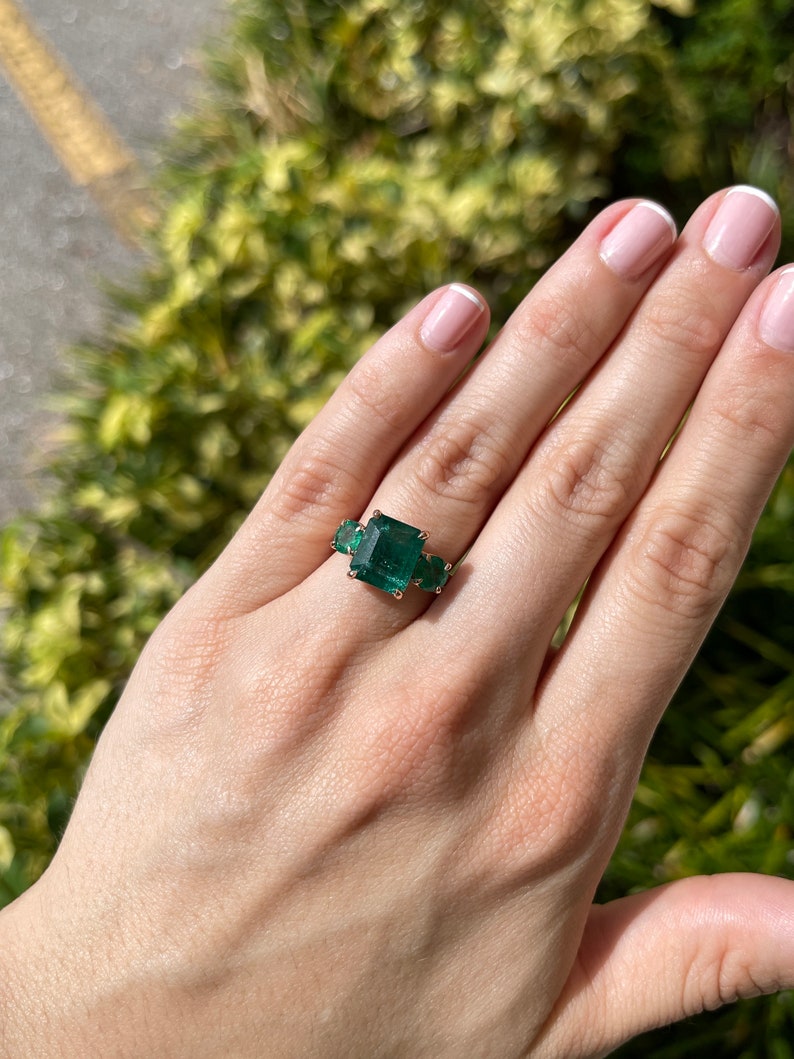 6.98 TCW Dark Green Emerald Cut & Round Trilogy Three Stone Engagement Ring in 14K Rose Gold - Perfect for Proposals, Anniversaries, and Special Occasions