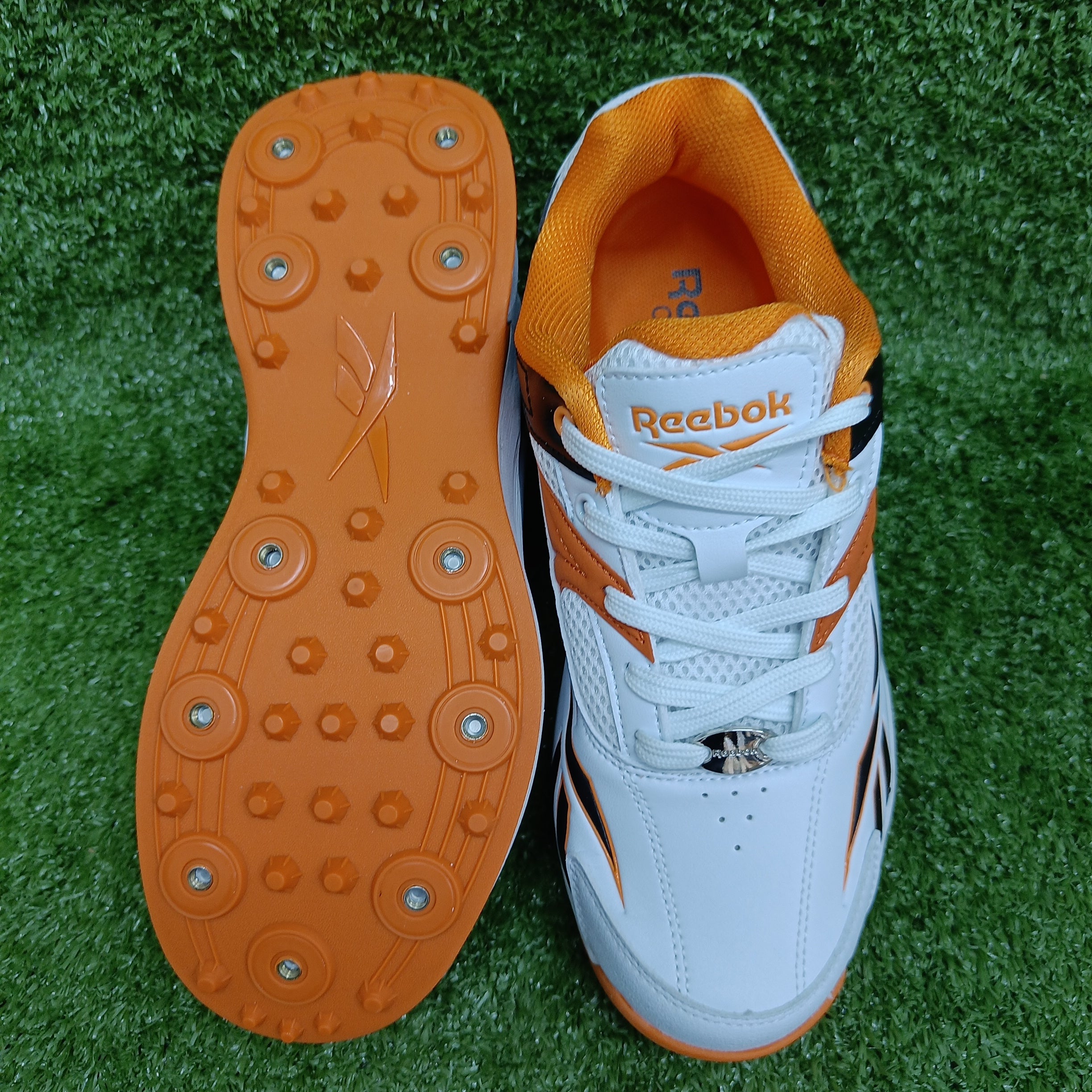 Reebok Not Out Syndicate Cricket Shoes - White, Black & Shocking Orange - Metal Spike Cleats for Enhanced Grip & Performance on the Pitch | Perfect for Professional & Amateur Cricket Matches