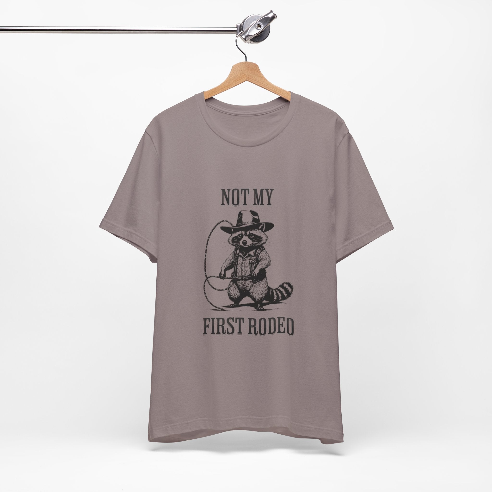 Funny Western Graphic Cotton Tee - Not My First Rodeo Cowboy Raccoon Shirt | Cute Quirky Country Style T-Shirt for Rodeo Fans & Animal Lovers | Perfect for Rodeo Events, Country Concerts & Casual Wear