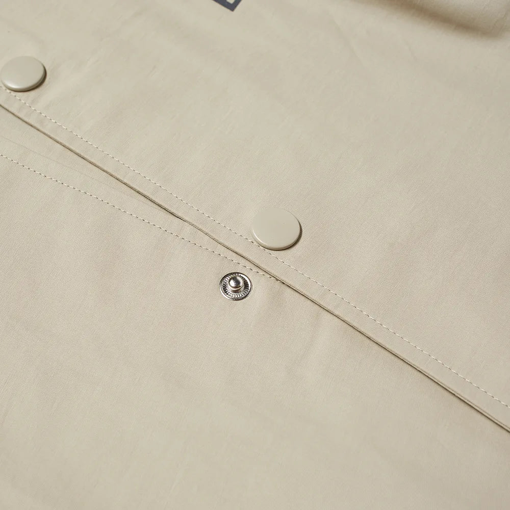 Fear of God Essentials Coach Jacket in Sage Green - Stylish Lightweight Outerwear for Men | Perfect for Casual Wear, Street Style & Layering