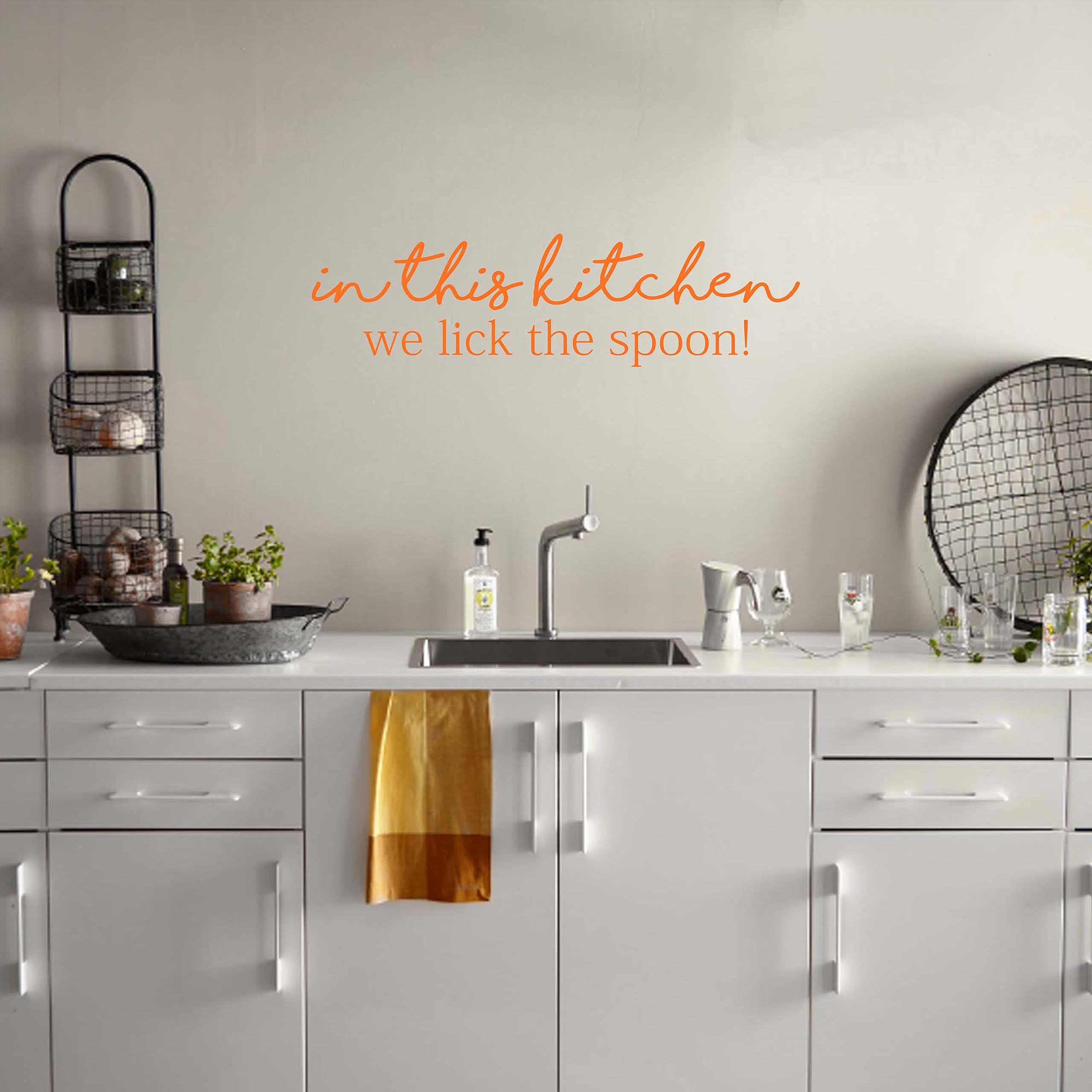 Kitchen Wall Decor Decal Sticker - 'In This Kitchen We Lick The Spoon' Funny Vinyl Sticker for Kitchen Door & Walls - Orange Peel & Stick Decoration - Perfect for Home, Apartment & Restaurant Decor