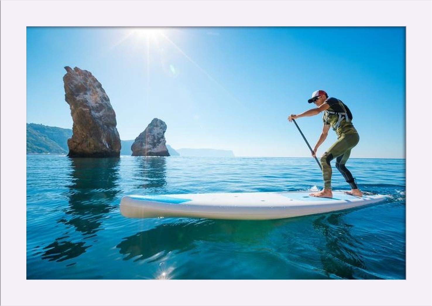 Premium 18x12 Giclee Art Print - Man Paddle Boarding on Blue Water with Sun & Rocks - Gallery Framed in White Wood - Perfect for Beach House Decor & Water Sports Enthusiasts