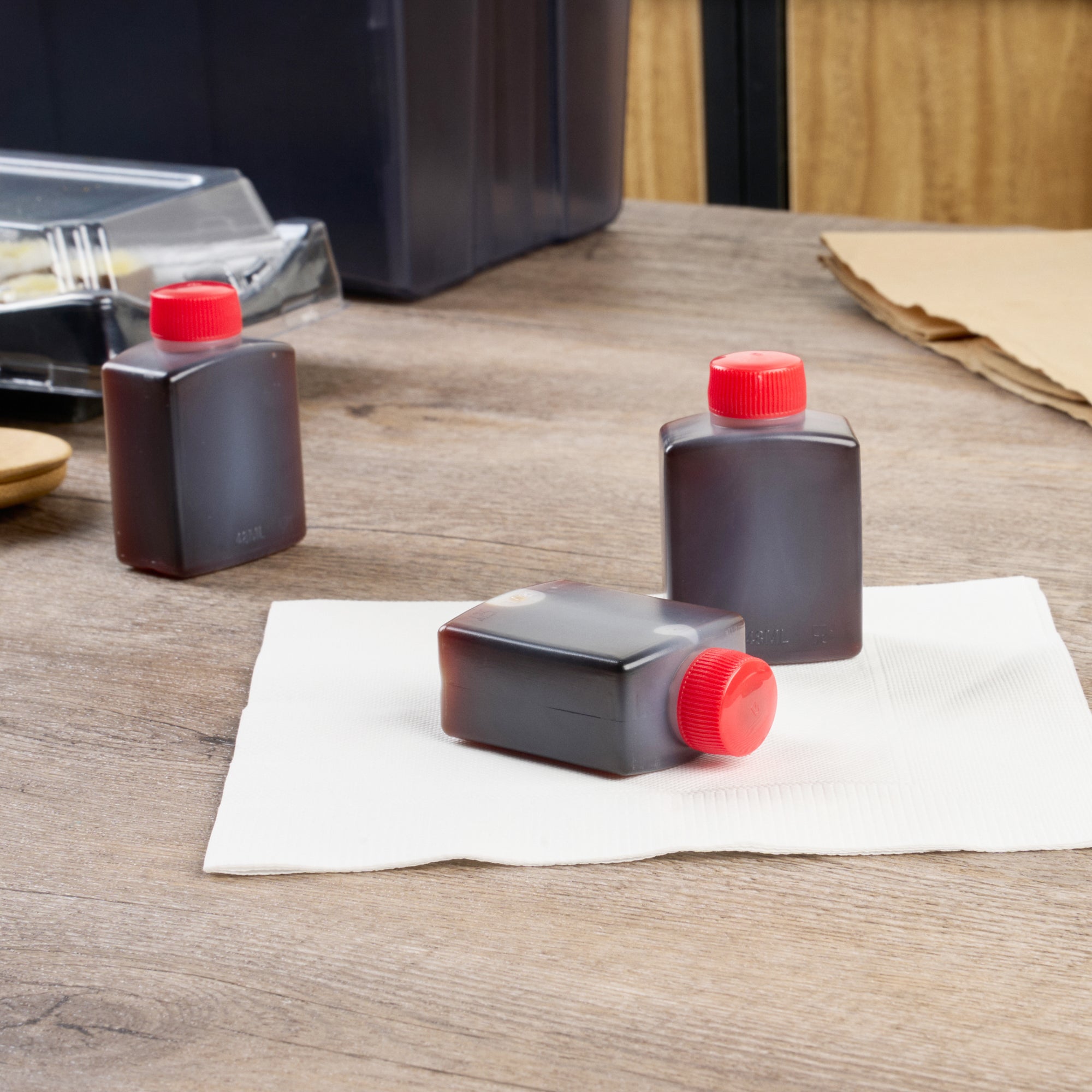 Bento Tek 2 oz Clear Plastic Soy Sauce Bottles with Red Caps - 1.5