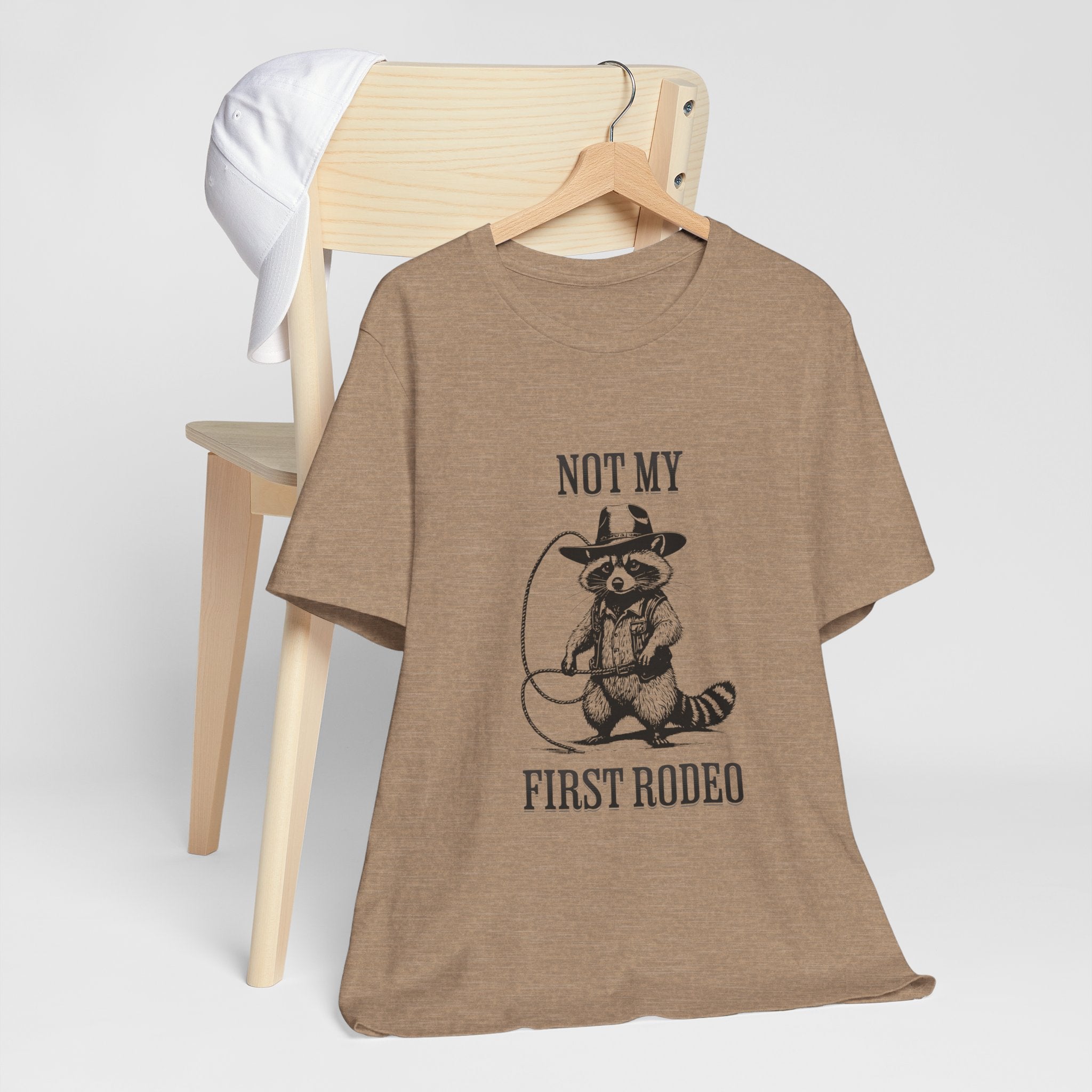 Funny Western Graphic Cotton Tee - Not My First Rodeo Cowboy Raccoon Shirt | Cute Quirky Country Style T-Shirt for Rodeo Fans & Animal Lovers | Perfect for Rodeo Events, Country Concerts & Casual Wear