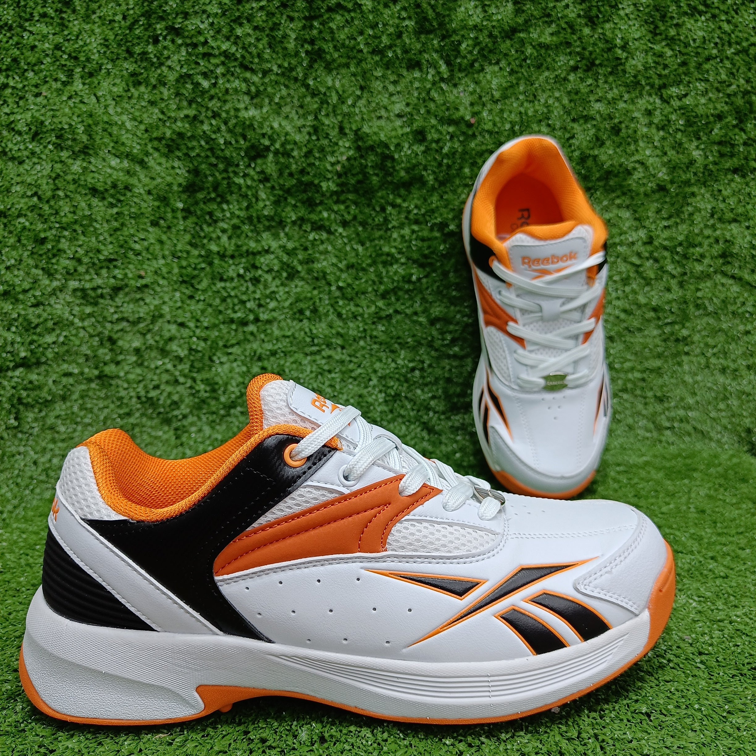 Reebok Not Out Syndicate Cricket Shoes - White, Black & Shocking Orange - Metal Spike Cleats for Enhanced Grip & Performance on the Pitch | Perfect for Professional & Amateur Cricket Matches