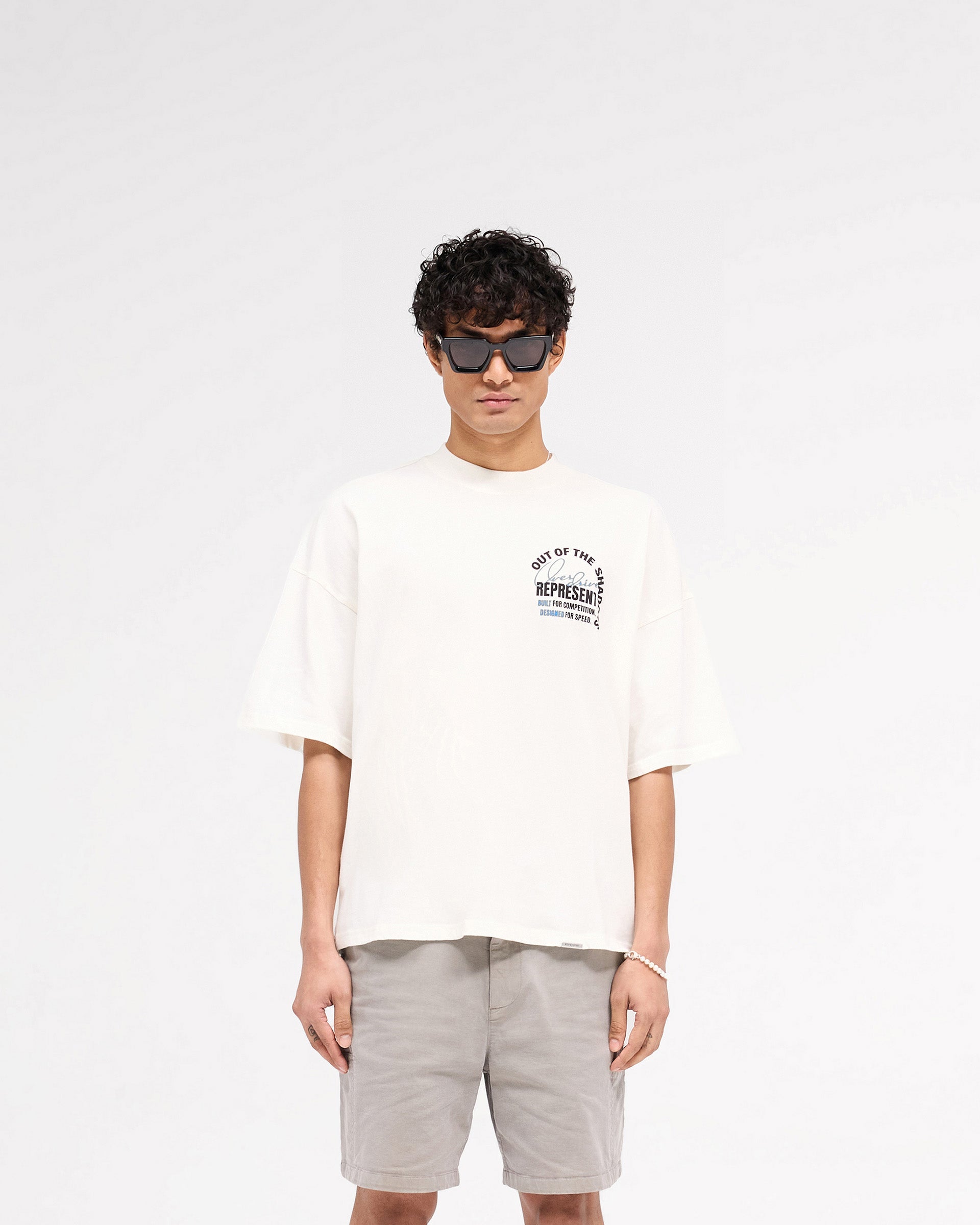 Out Of The Shadows Graphic T-Shirt - Flat White Color | Trendy Streetwear for Men & Women | Perfect for Casual Wear, Concerts, and Everyday Outfits