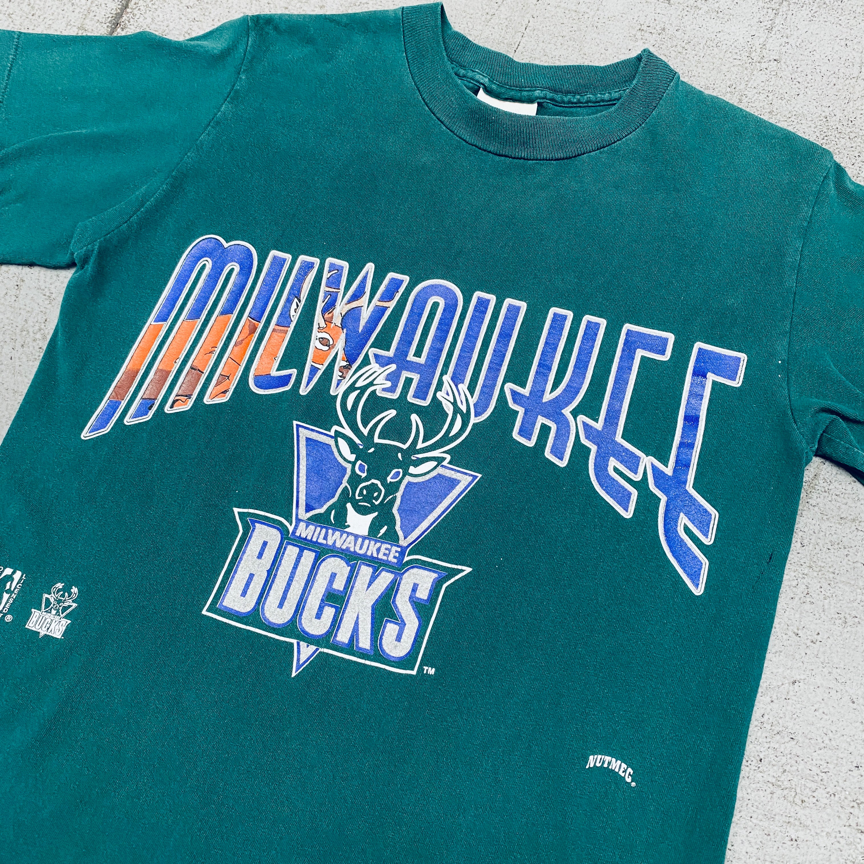 Milwaukee Bucks 1990s Vintage Graphic Spellout T-Shirt - Nutmeg Mills Retro NBA Basketball Tee for Men - Perfect for Game Day, Casual Wear & Fan Collections