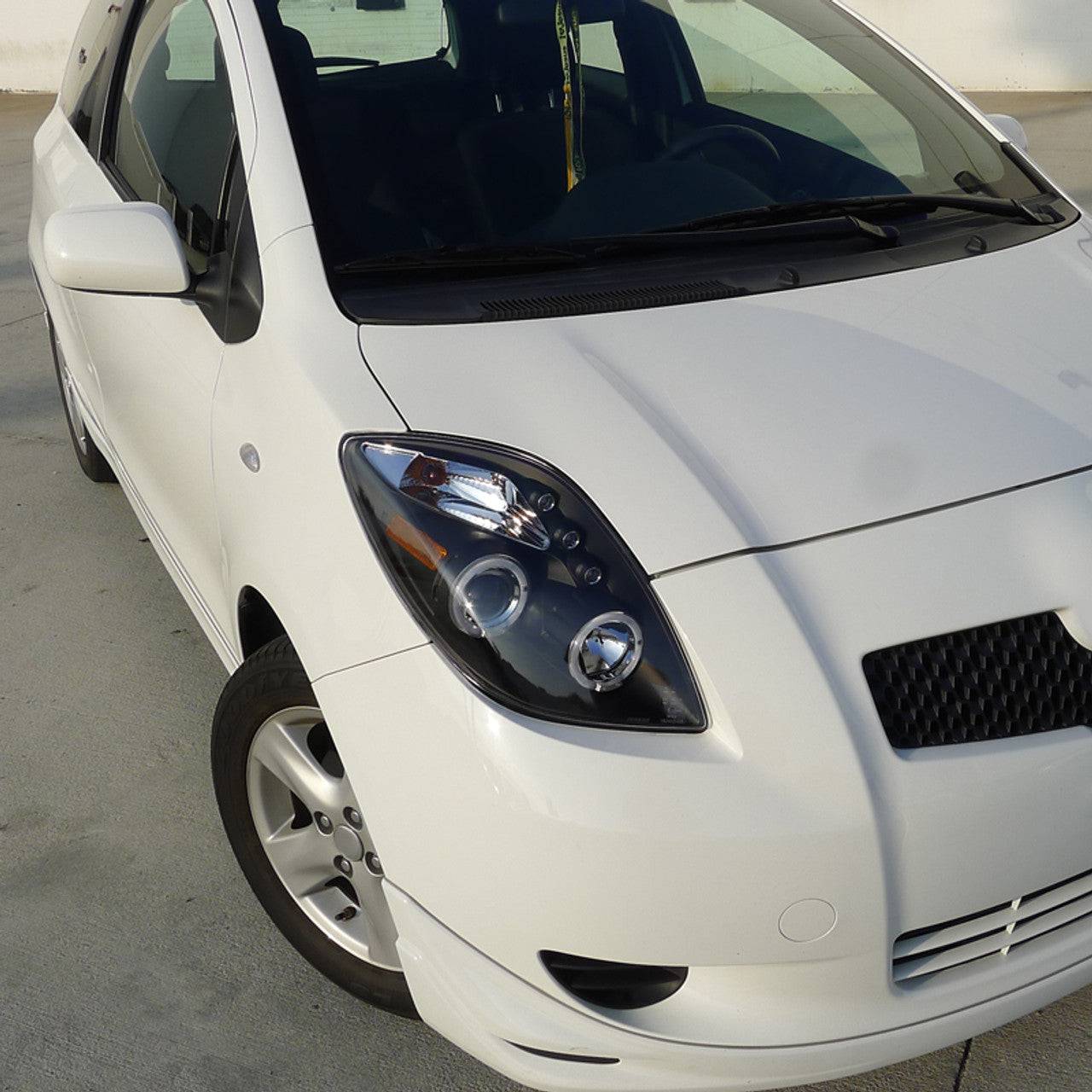 2006-2008 Toyota Yaris Halo Projector Headlights - Matte Black Housing with Clear Lens - LED Angel Eye Headlight Assembly for Night Driving & Car Customization