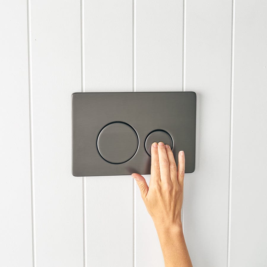 Angled In-Wall Toilet with Round Gunmetal Buttons - Modern Space-Saving Design for Small Bathrooms and Commercial Spaces