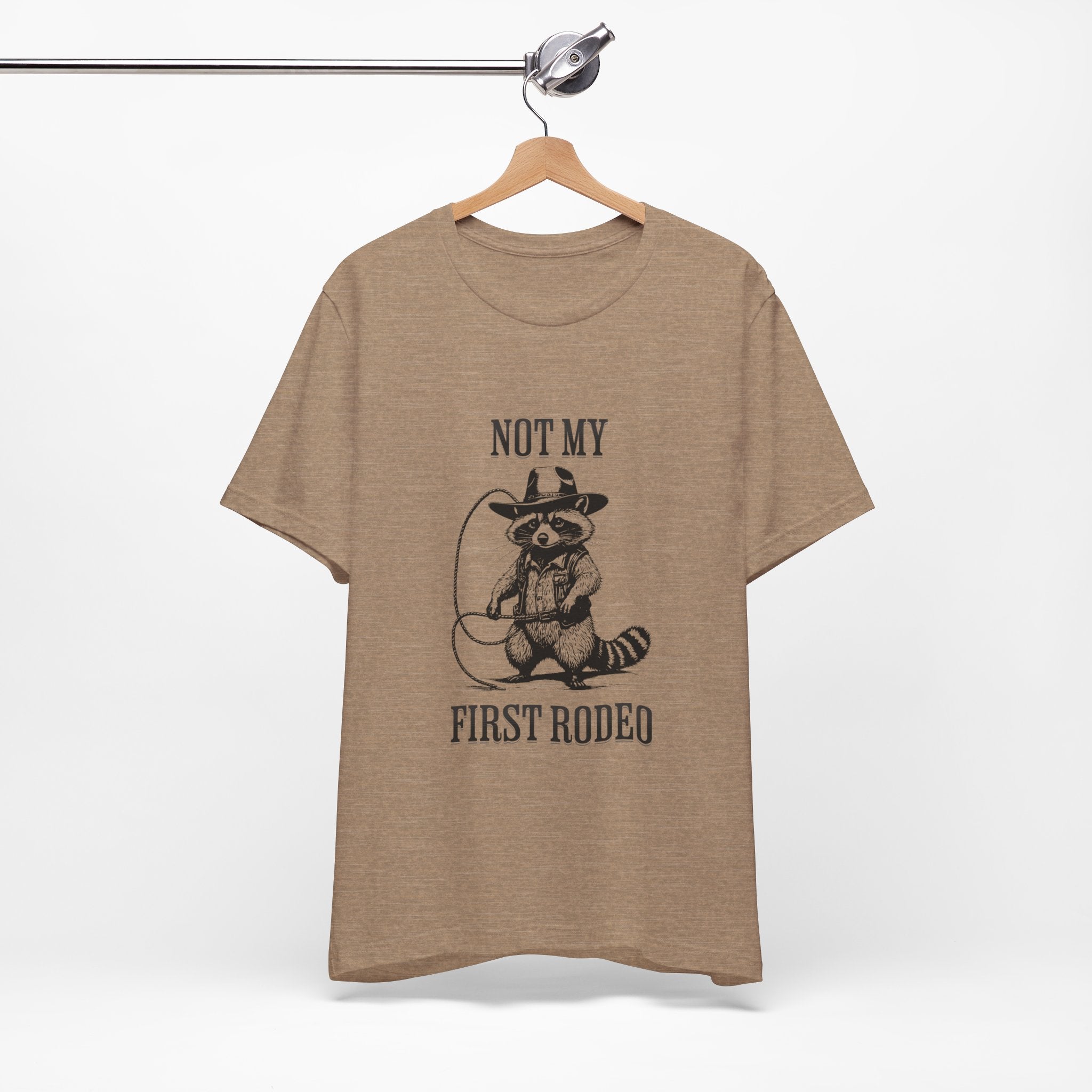 Funny Western Graphic Cotton Tee - Not My First Rodeo Cowboy Raccoon Shirt | Cute Quirky Country Style T-Shirt for Rodeo Fans & Animal Lovers | Perfect for Rodeo Events, Country Concerts & Casual Wear