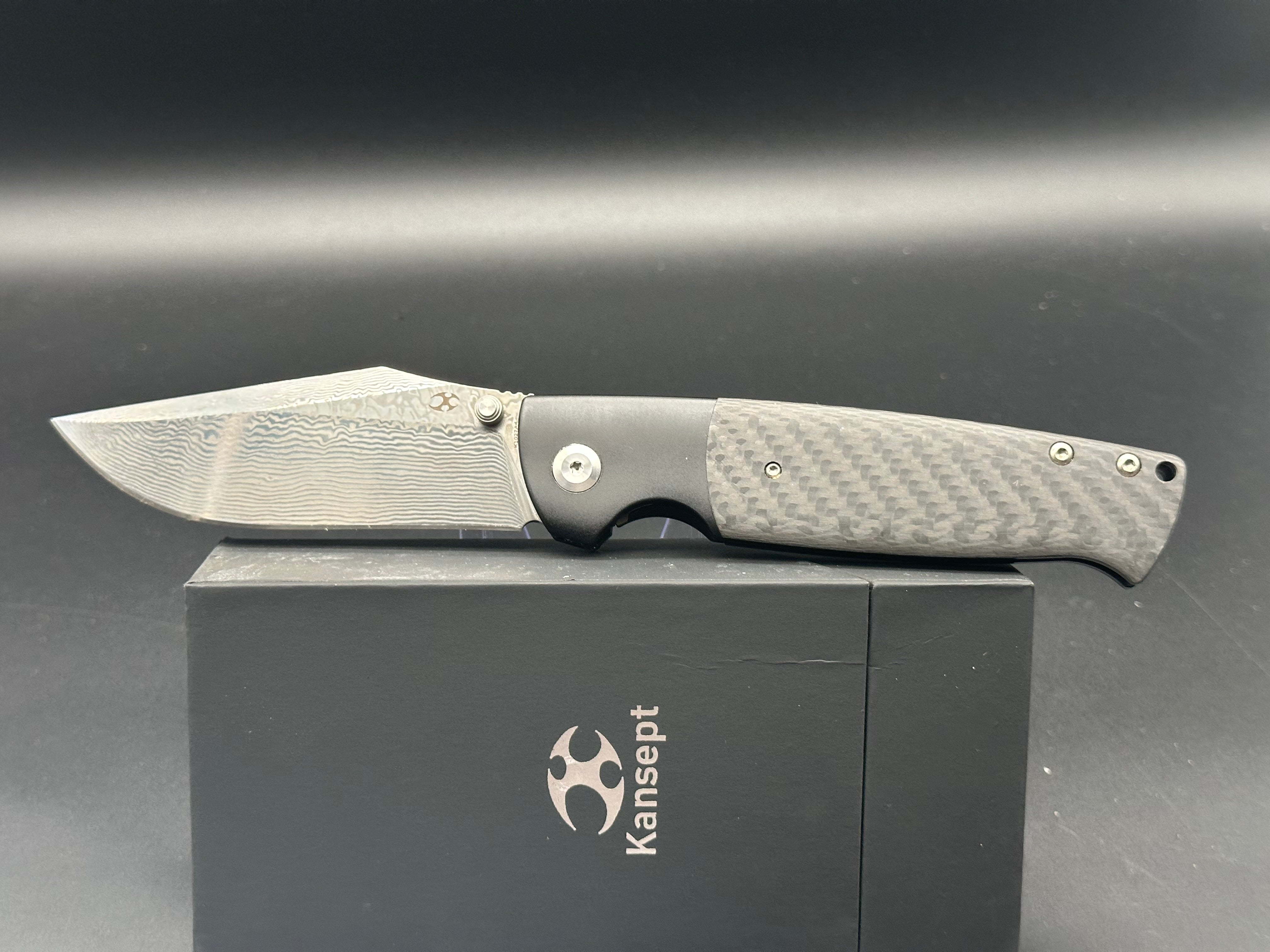 KANSEPT SHIKARI Folding Knife - Black Titanium Handle with Twill Carbon Fiber Inlay & Damascus Steel Blade - Plain Edge for Outdoor, Camping, and EDC Use