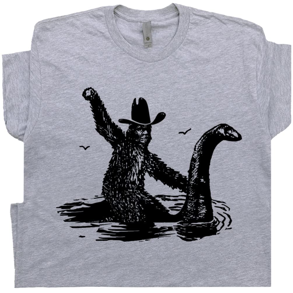 Bigfoot Sasquatch Riding Loch Ness Monster Cryptid Graphic T-Shirt for Men & Women - Unique Cryptozoology Tee for Fans of Weird Creatures & Mythical Legends | Perfect for Halloween, Cosplay & Gift Giving