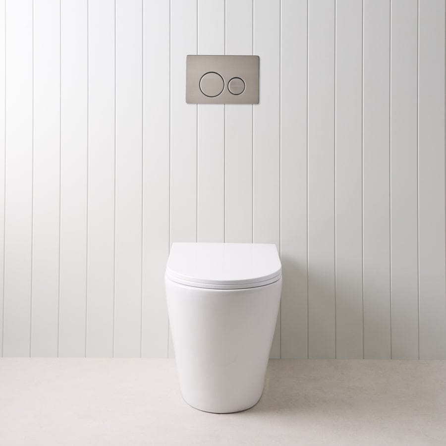 Angled In-Wall Toilet with Round Gunmetal Buttons - Modern Space-Saving Design for Small Bathrooms and Commercial Spaces