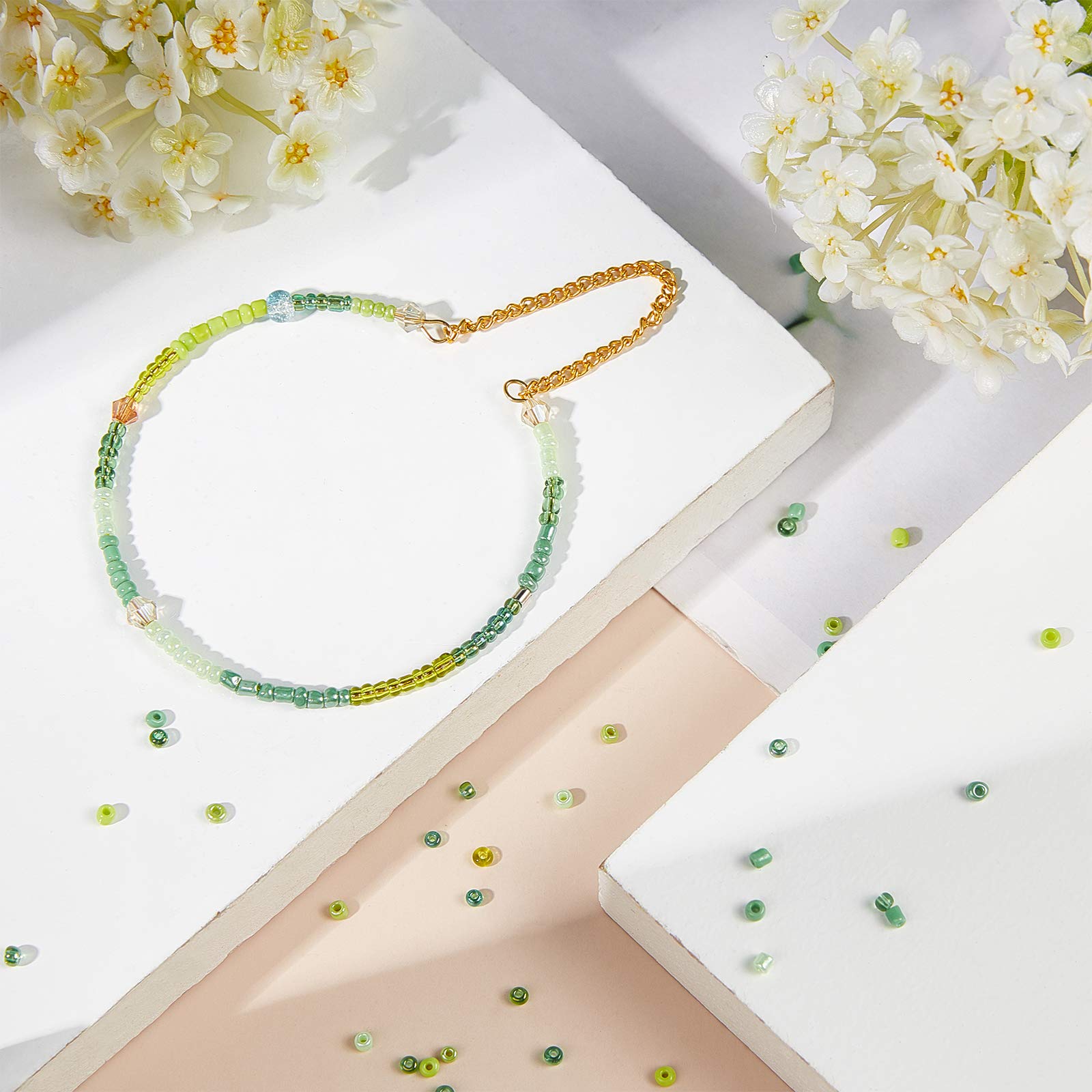 NBEADS 12500 Pcs 2mm Small Glass Seed Beads for Jewelry Making, 12/0 Mini Craft Beads with 1mm Hole - 8 Shades of Green for Christmas Bracelets, Earrings, Necklaces & DIY Gift Projects