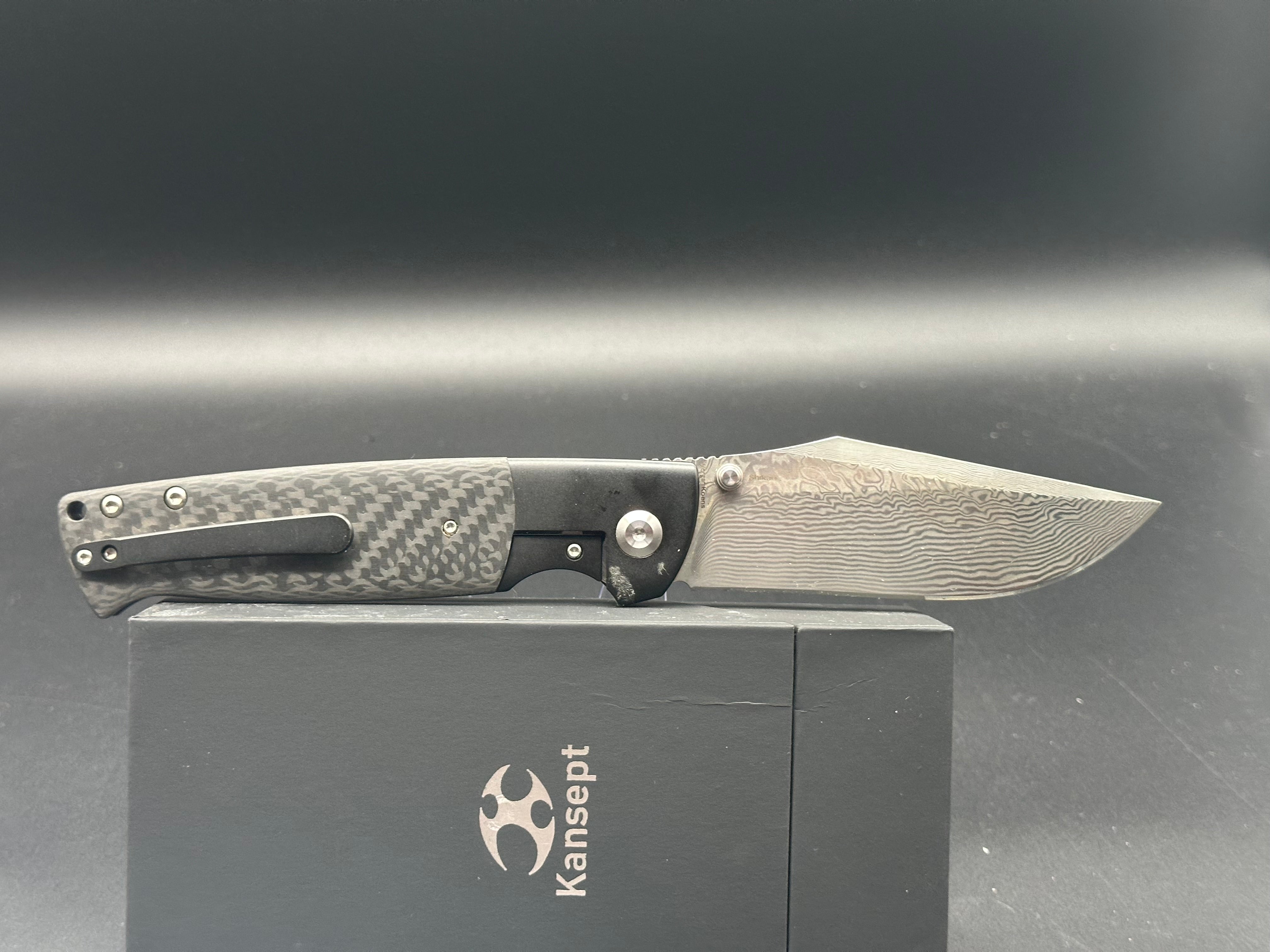 KANSEPT SHIKARI Folding Knife - Black Titanium Handle with Twill Carbon Fiber Inlay & Damascus Steel Blade - Plain Edge for Outdoor, Camping, and EDC Use