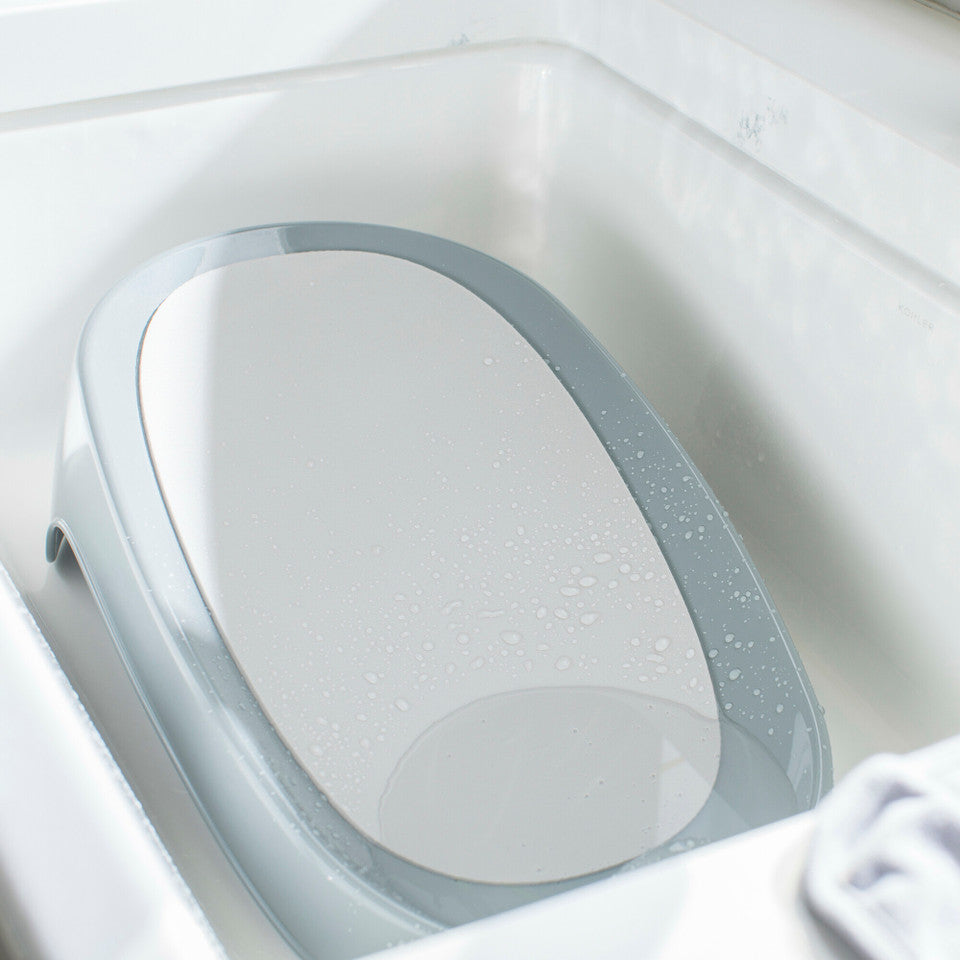 The First Years Sure Comfort Renewed Baby Bather - Newborn & Infant Bathtub with Soft Support for Safe Bathing at Home or Travel