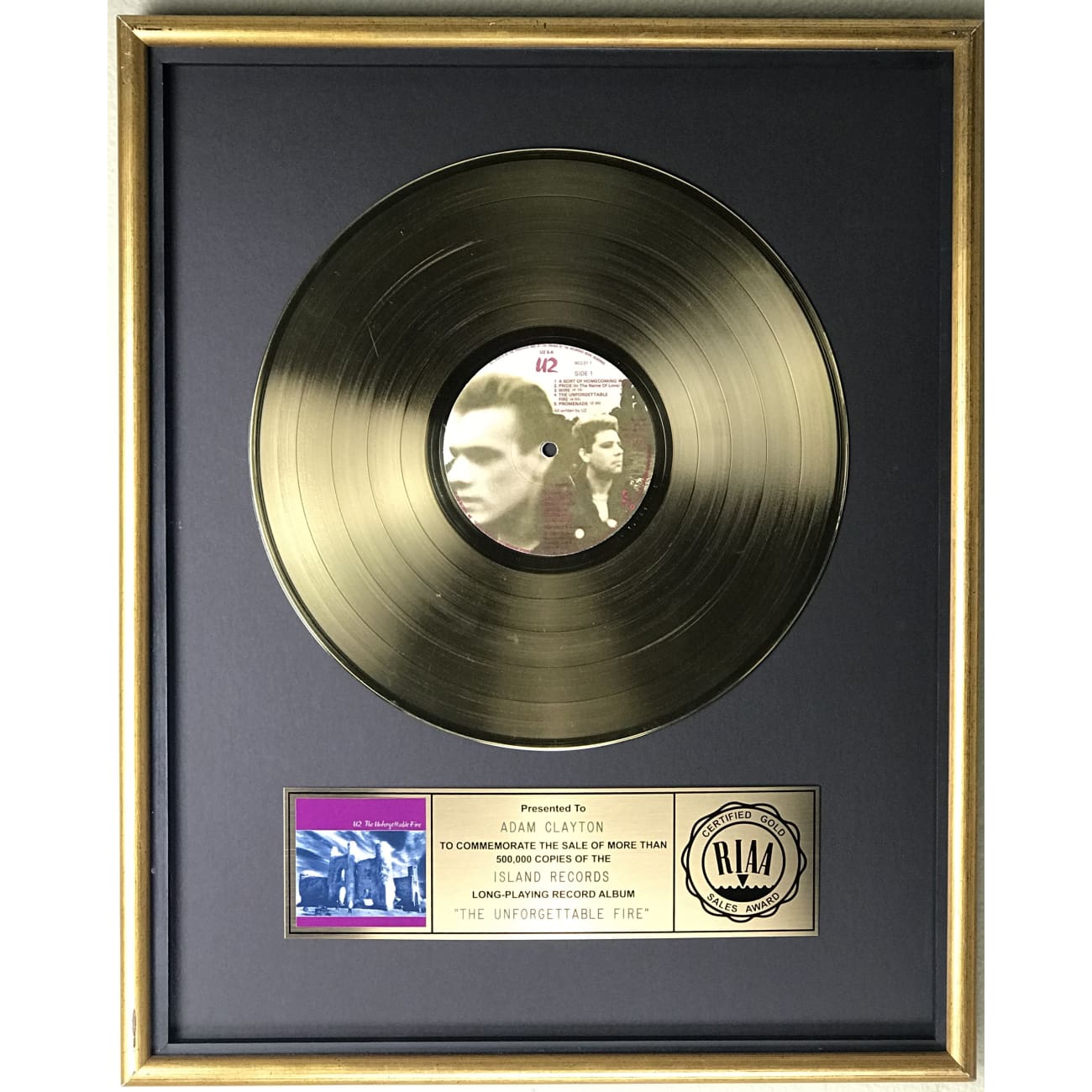 U2 The Unforgettable Fire RIAA Gold LP Award Presented to Adam Clayton - Rare Collectible Vinyl Record for Music Enthusiasts & U2 Fans - Perfect for Display in Music Rooms, Theaters, or Collector's Showcases