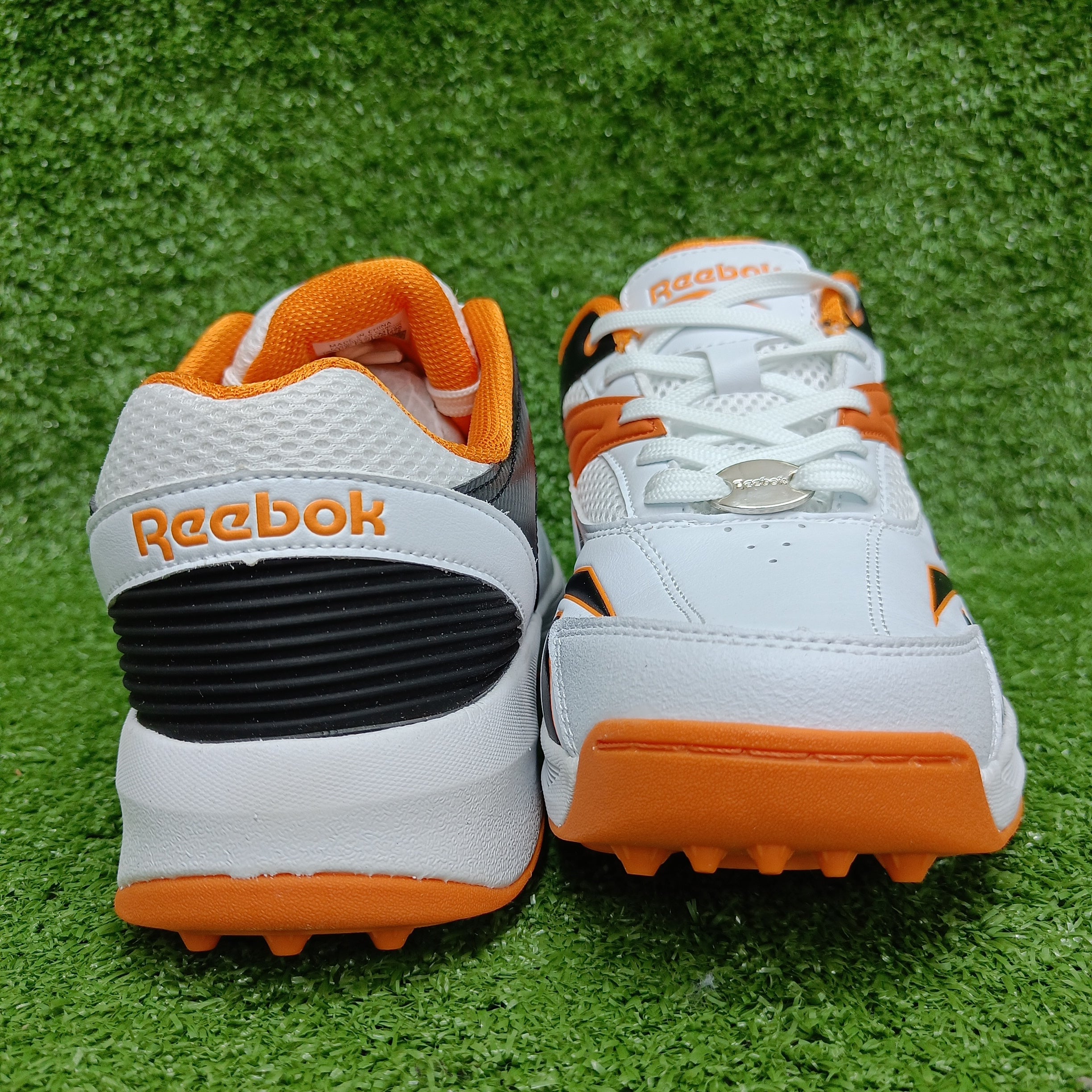 Reebok Not Out Syndicate Cricket Shoes - White, Black & Shocking Orange - Metal Spike Cleats for Enhanced Grip & Performance on the Pitch | Perfect for Professional & Amateur Cricket Matches