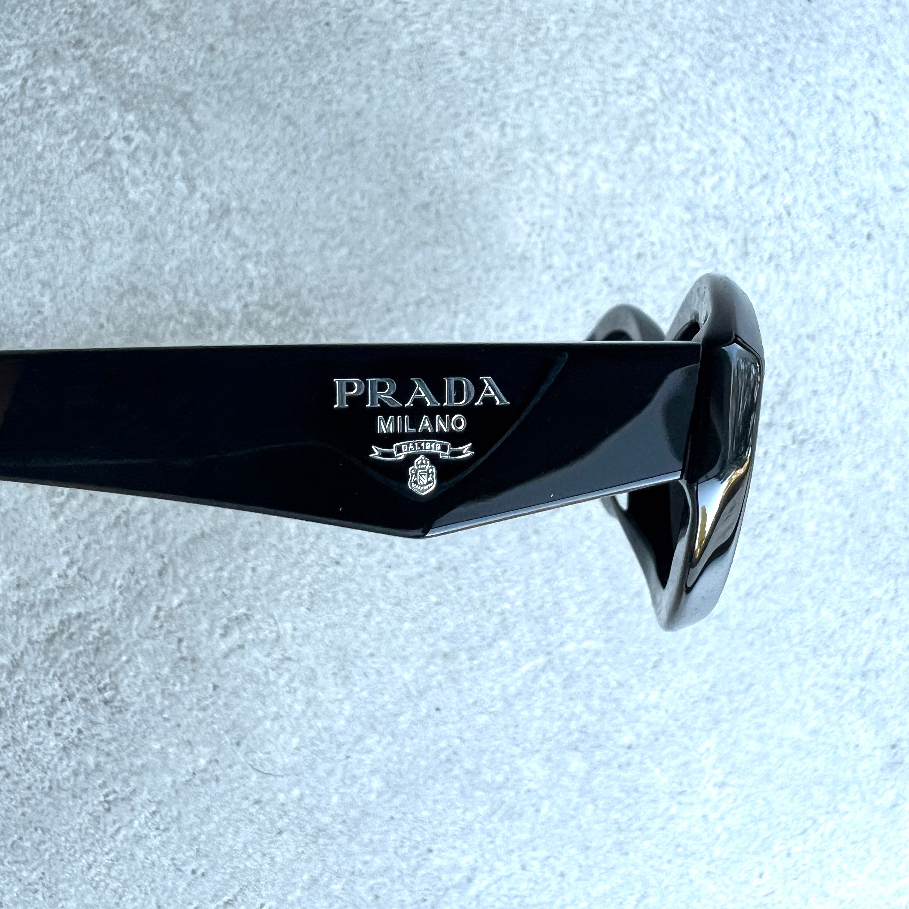 PRADA PR26ZSF Symbole Oval Sunglasses for Women - Black Cat Eye Sunglasses with UV Protection | Perfect for Beach, Driving & Fashion Accessories