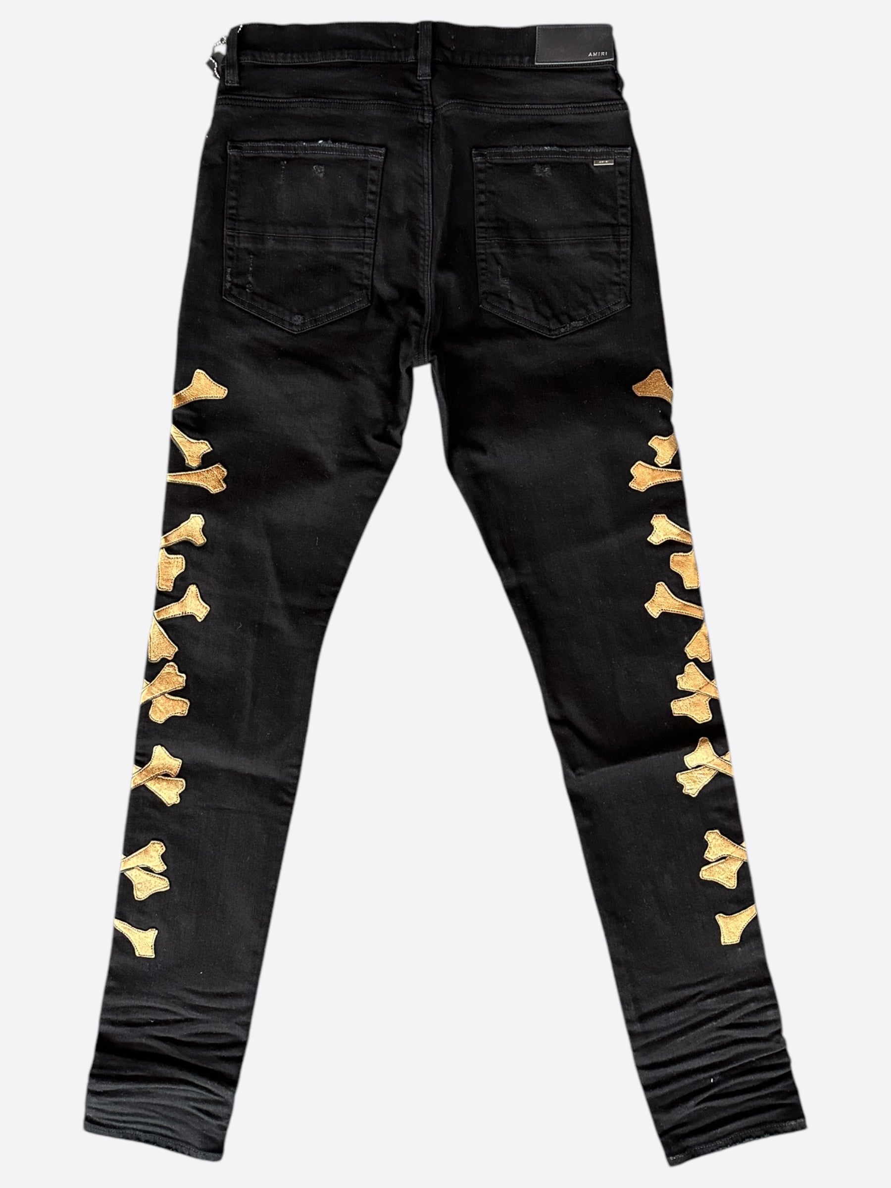 Amiri Black & Gold Bones Applique Distressed Jeans for Men - High Quality Designer Denim Pants | Perfect for Streetwear & Night Out Fashion