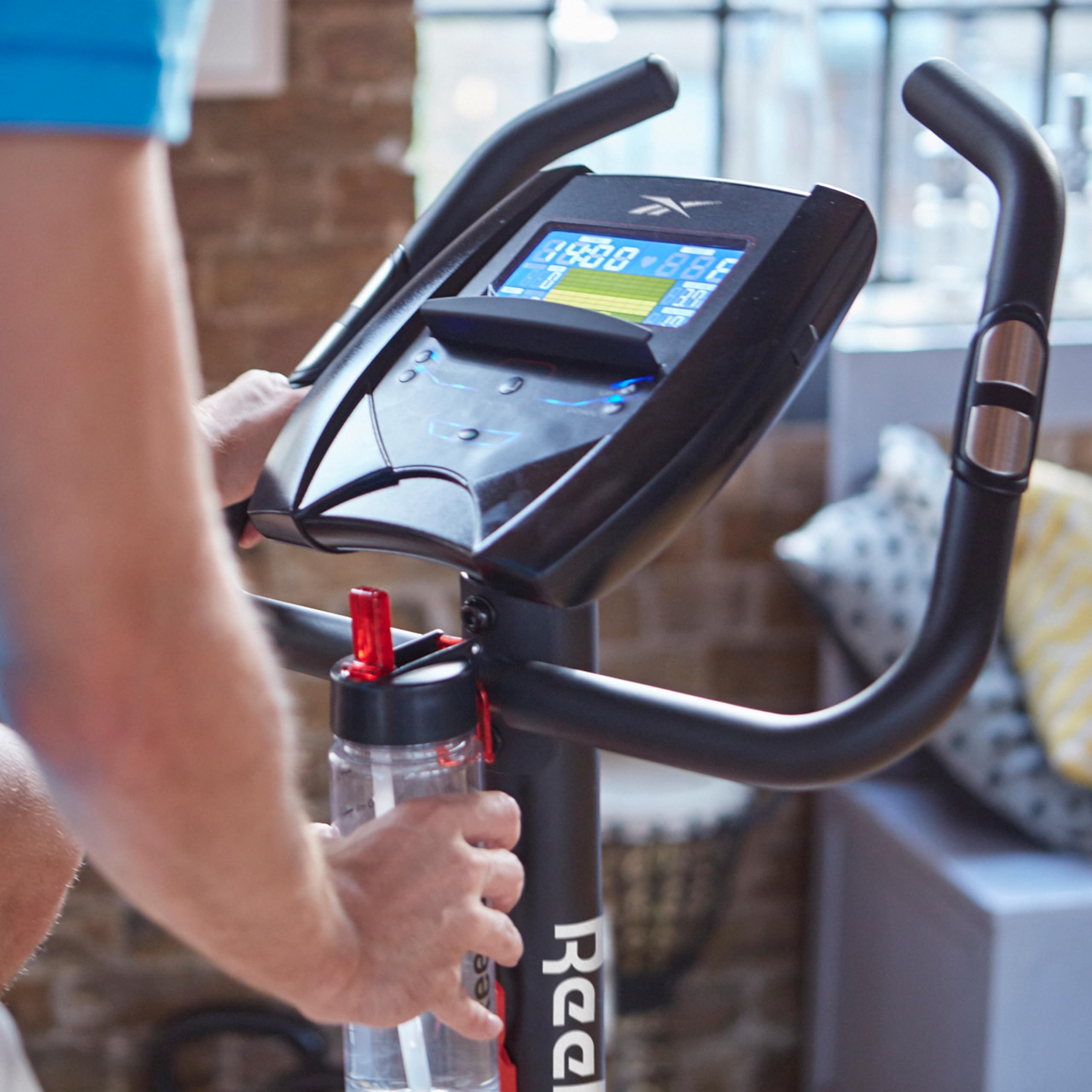 Reebok Fitness Stationary Bike - Bluetooth Indoor Cycling Bike with 24 Resistance Levels & 12 Workout Programs | Upright Exercise Bike with Gel Pad Saddle for Home Gym, Cardio Training & Weight Loss