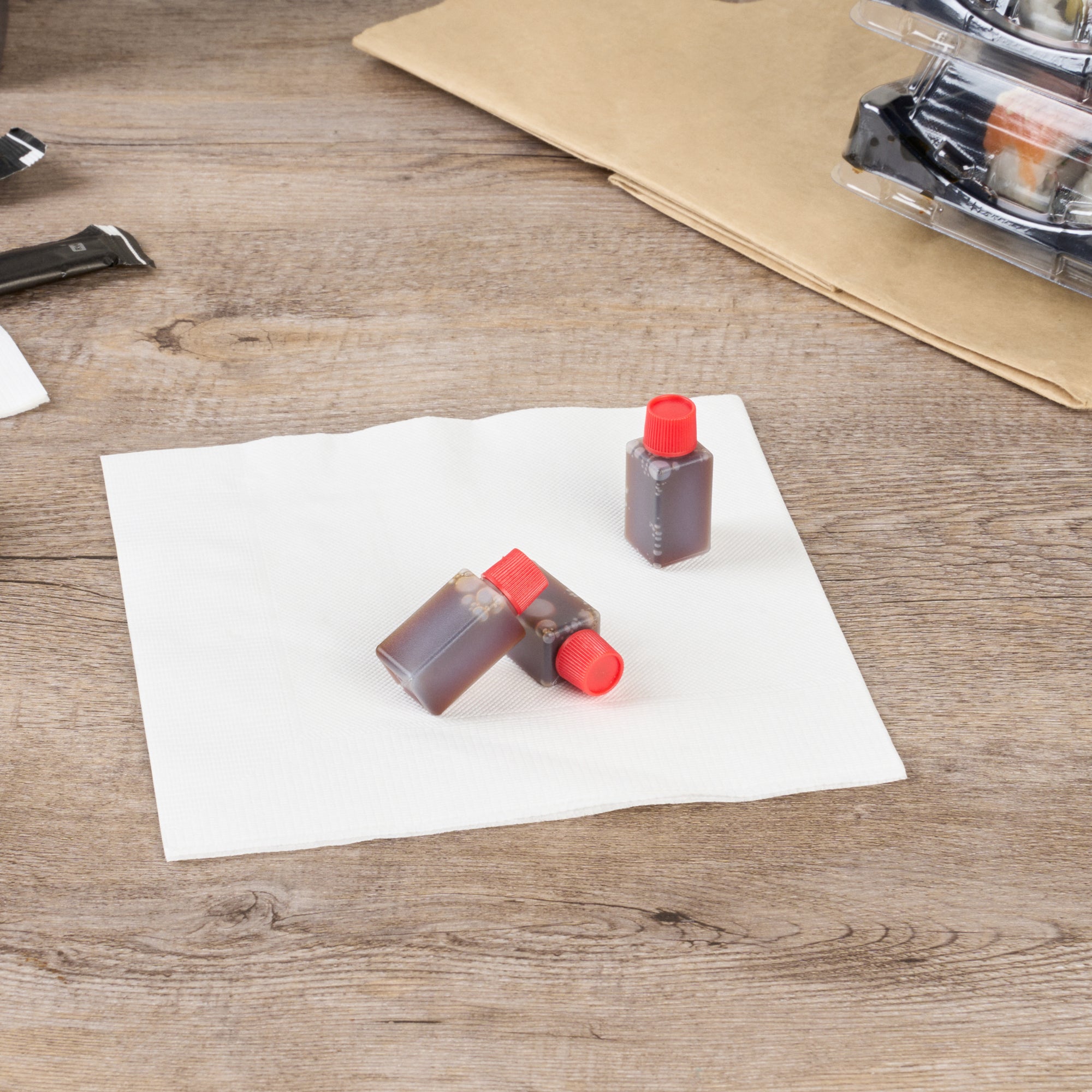 Bento Tek 6mL Clear Plastic Soy Sauce Bottles with Red Caps - 1/2
